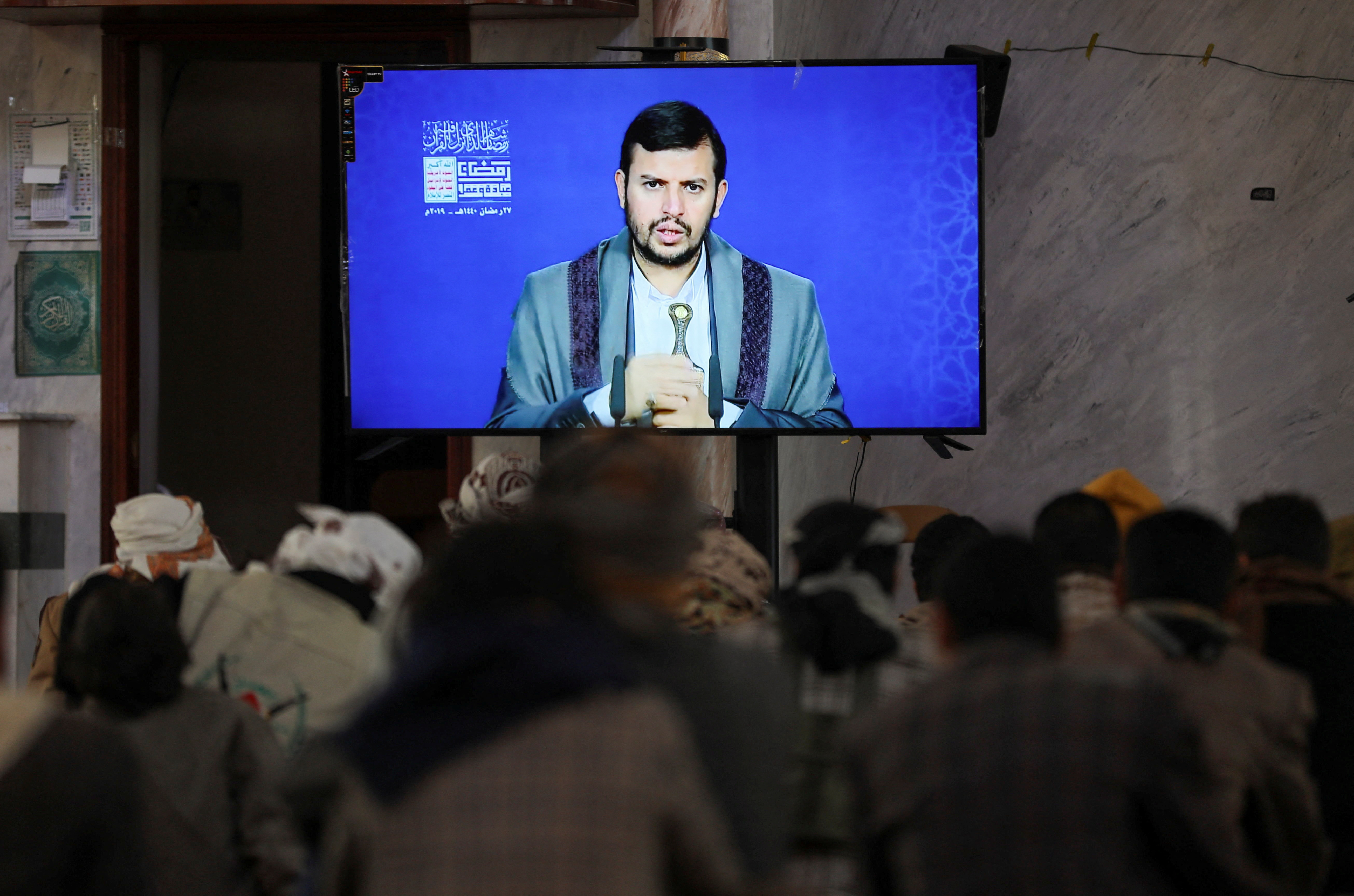 Newly recruited Houthi fighters watch a recorded lecture on Israel and the Jews by the Houthi movement's top leader, Abdul-Malik al-Houthi, during a ceremony at the end of their training in Sanaa, Yemen January 11, 2024. REUTERS/Khaled Abdullah