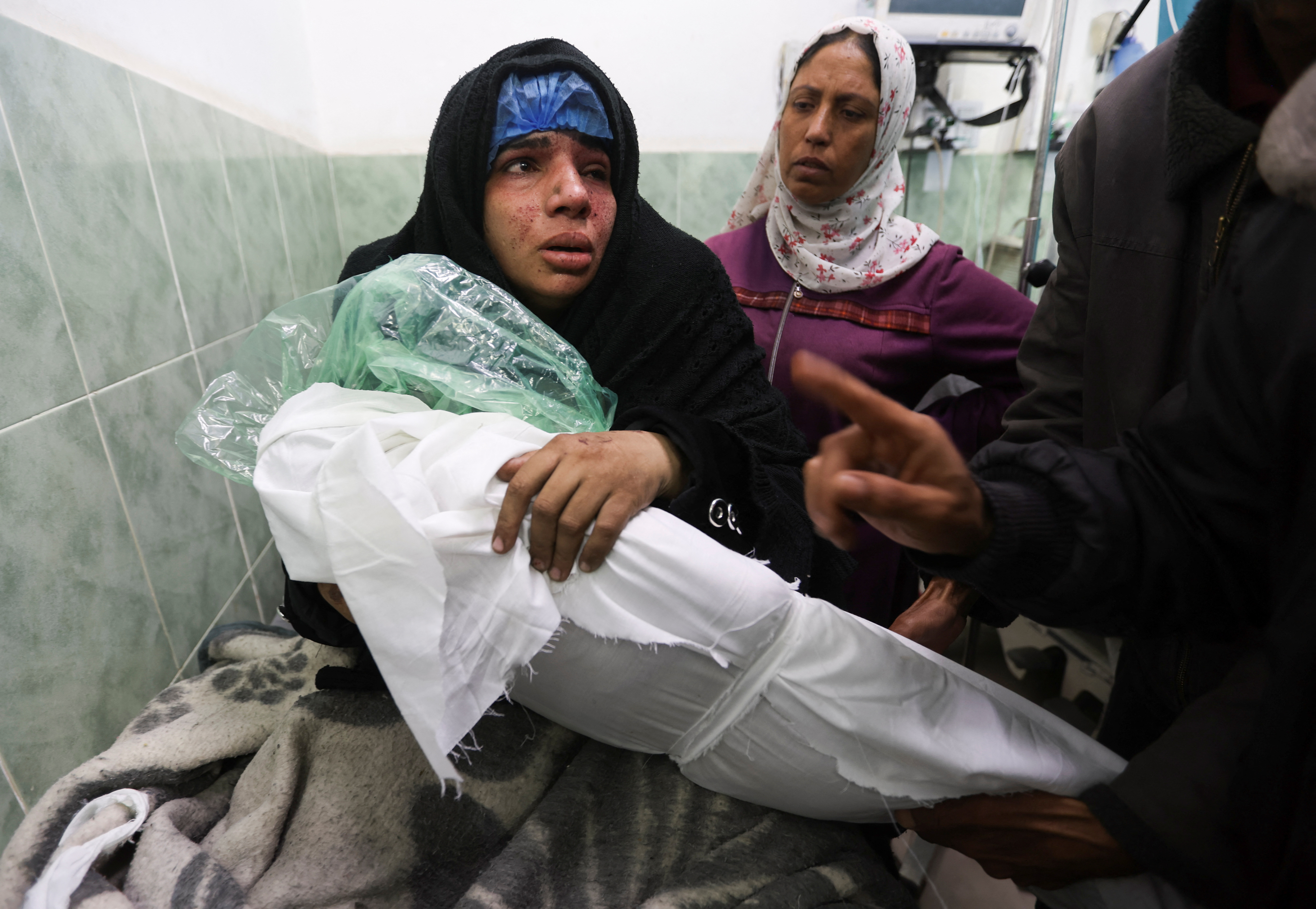 Palestinian Doaa Abu Lashin reacts on seeing her daughter Zeinab Abu Lashin, who was killed in an Israeli attack