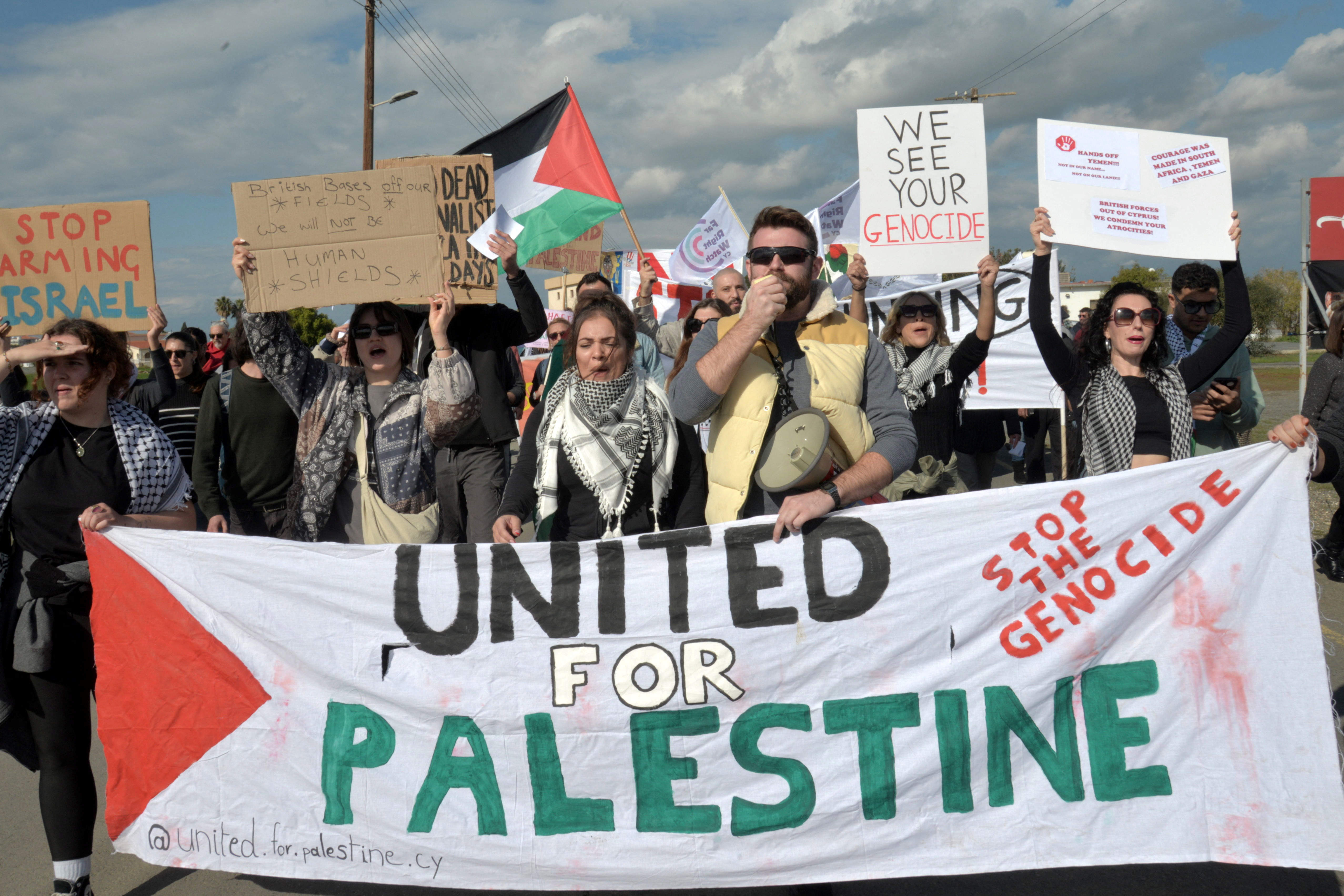 Left-wing activists shout slogans during a protest at the gates of RAF Akrotiri, the British base on Cyprus which has been used as a launchpad for strikes against the Houthi militia in Yemen, near the city of Limassol, Cyprus January 14, 2024. REUTERS/Marcos Andronicou NO RESALES. NO ARCHIVES