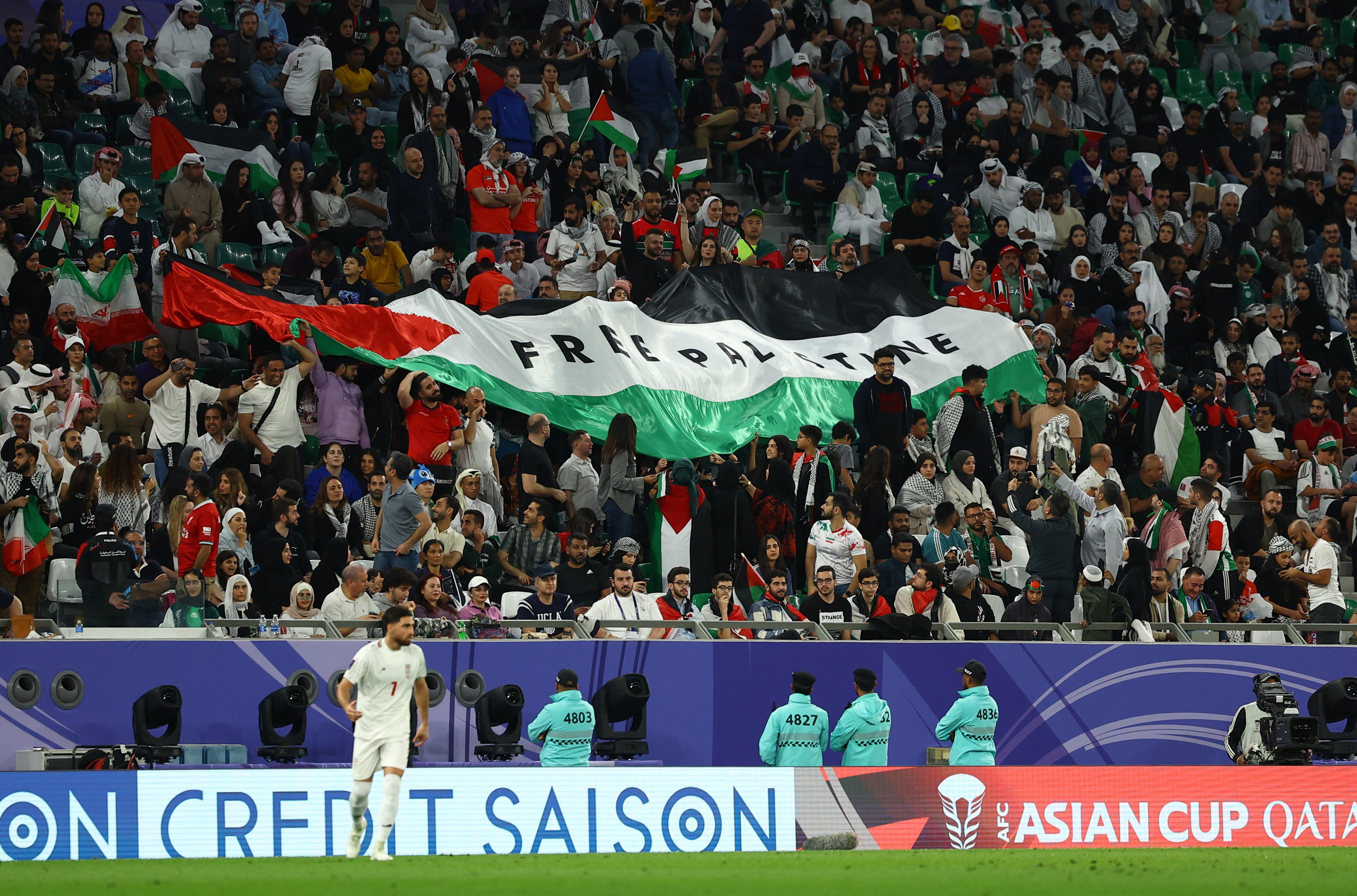 Soccer Football - AFC Asian Cup - Group C - Iran v Palestine - Education City Stadium, Al Rayyan, Qatar - January 14, 2024 A Palestine banner is displayed by fans amid the ongoing conflict between Israel and Hamas