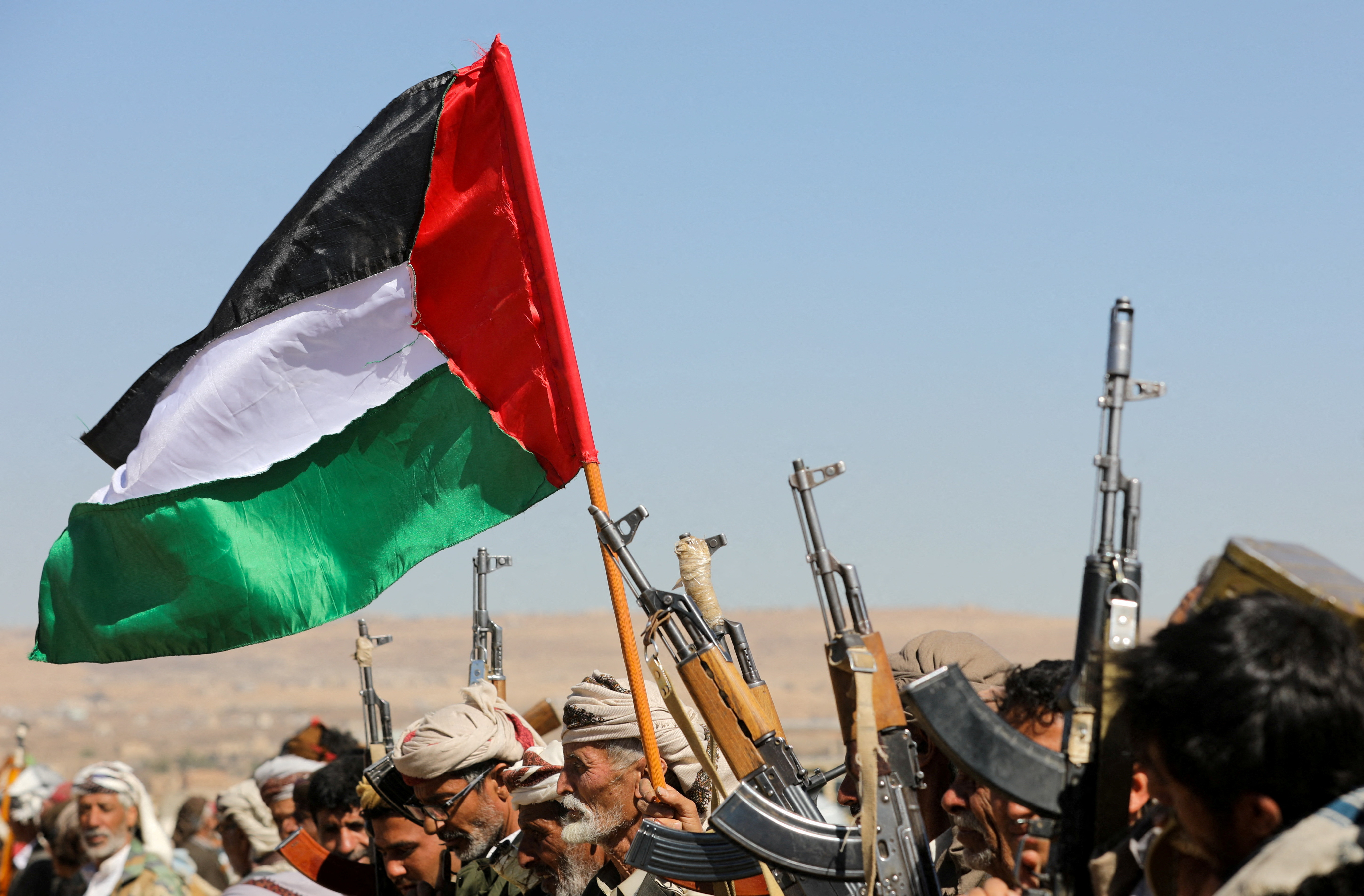 supporters of Yemen's Houthis wave a Palestinian flag