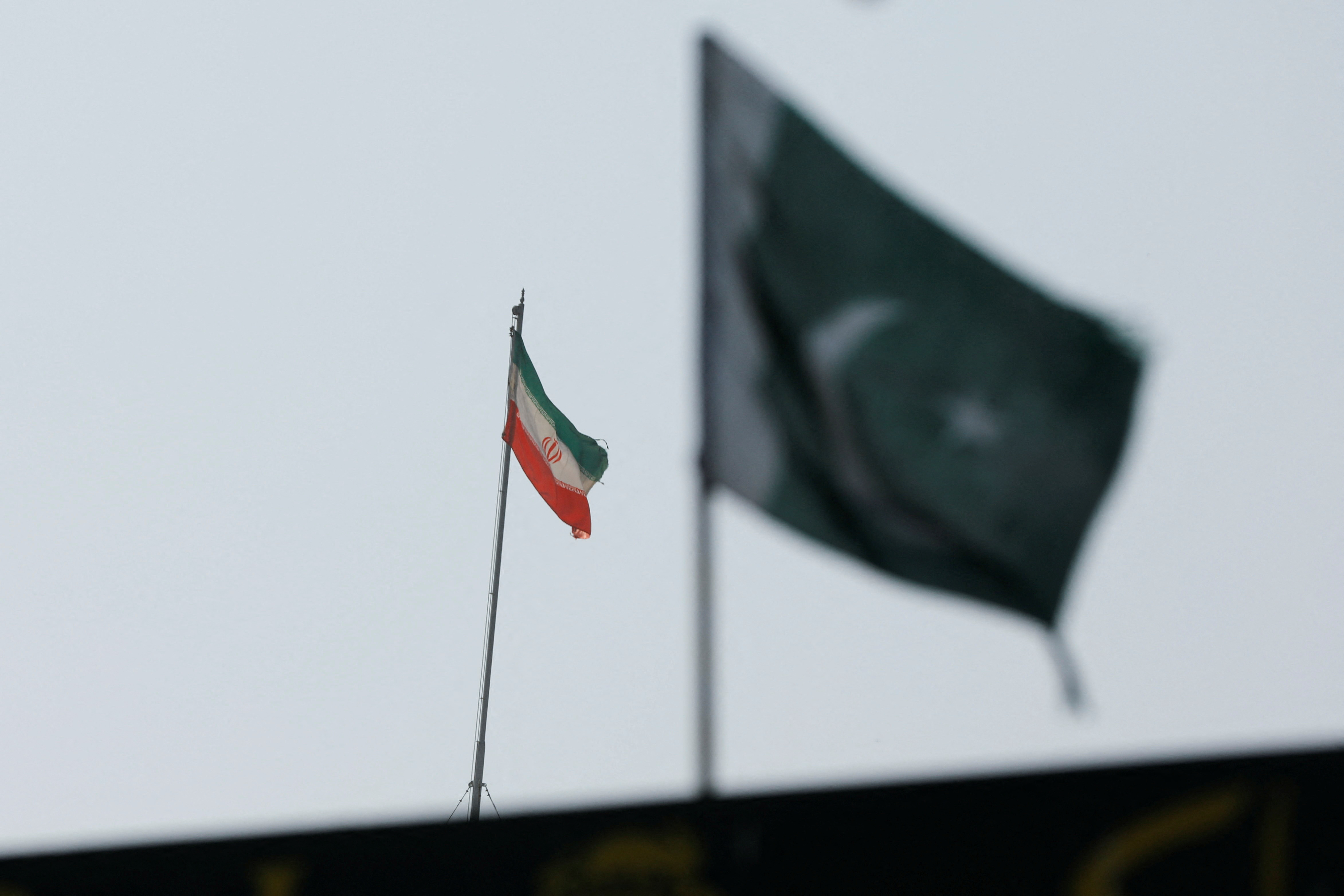 The flag of Iran is seen over its consulate building, with Pakistan's flag