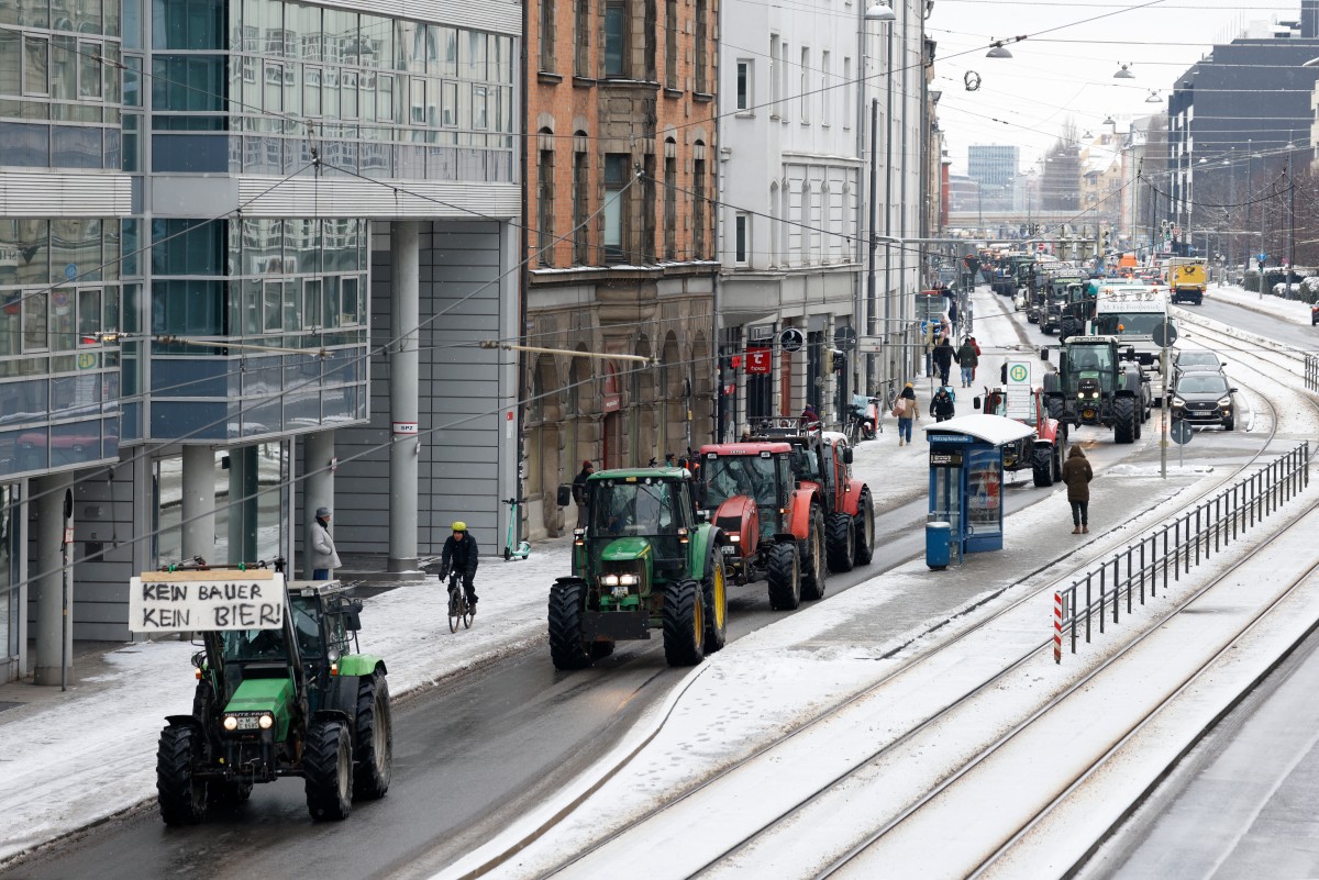 Farmers on their tractors drive through the city center as they take part in protests against the federal government's austerity plans in Munich