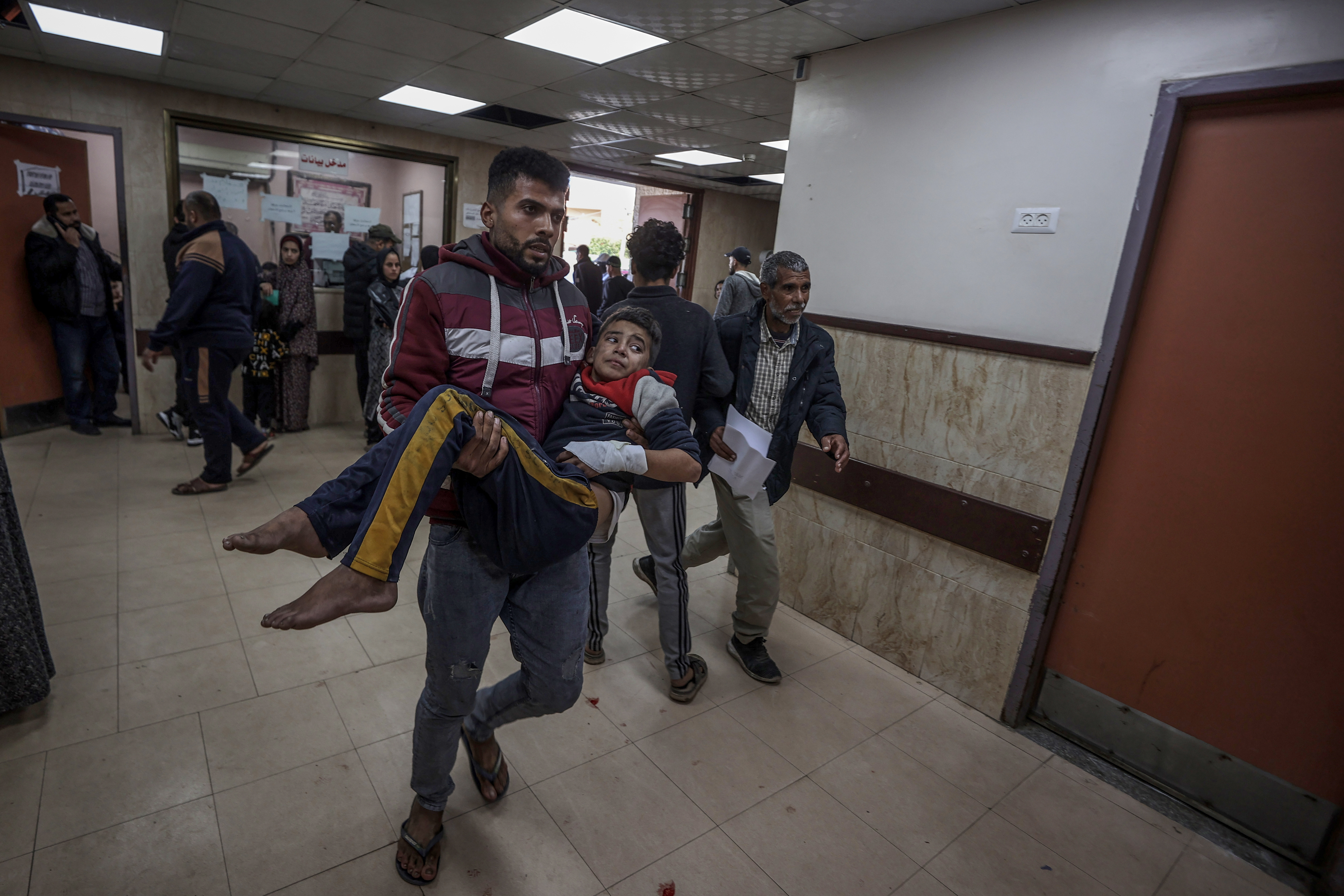 Wounded people, including children, are brought to Al-Aqsa Martyrs Hospital for treatment following the Israeli attacks in Deir al-Balah, Gaza.