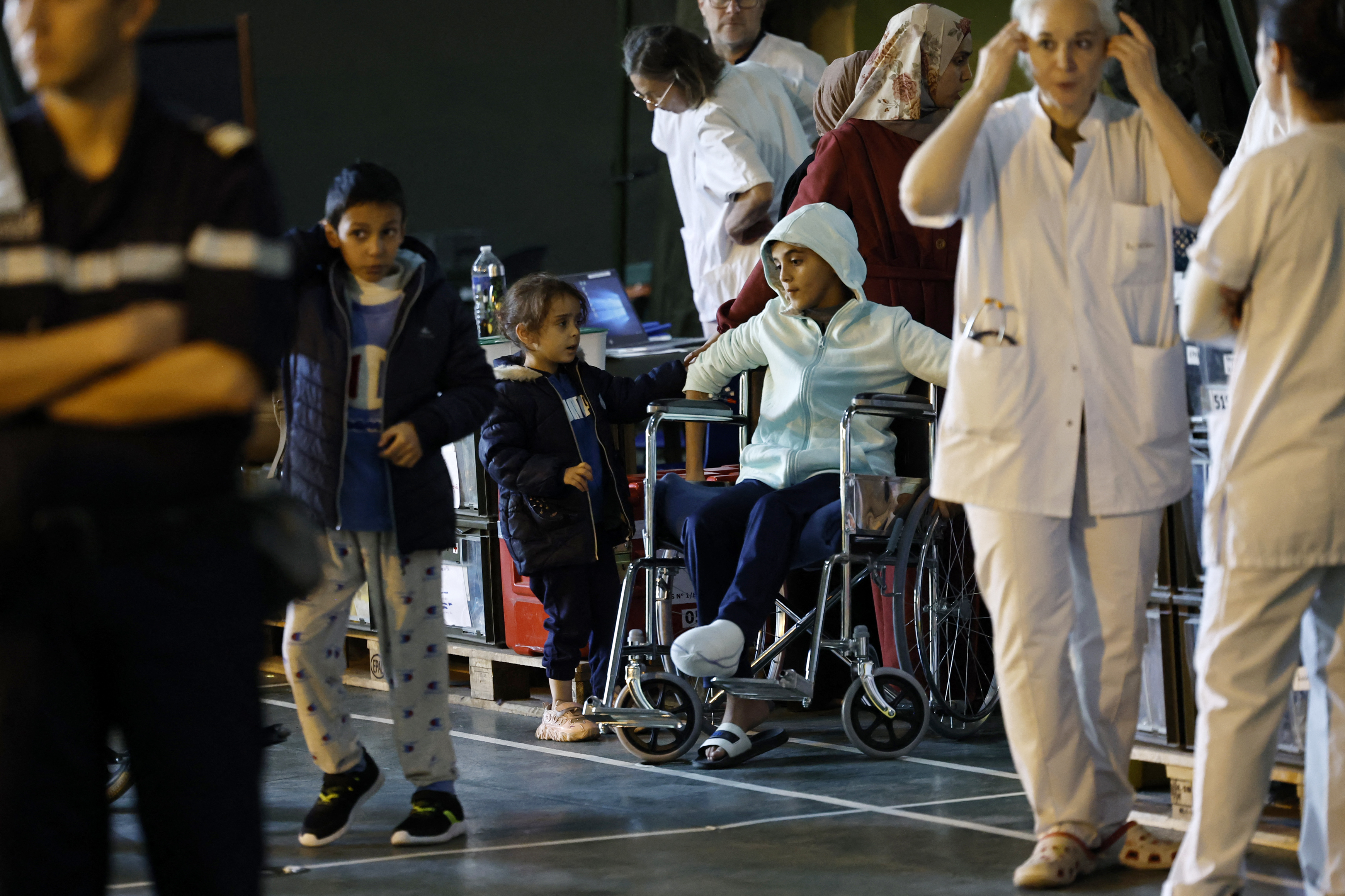 A Palestinian child sits on wheelchairs onboard the French LHD Dixmude military ship, which serves as a hospital to treat wounded Palestinians, as it docks at the Egyptian port of Al-Arish on January 21