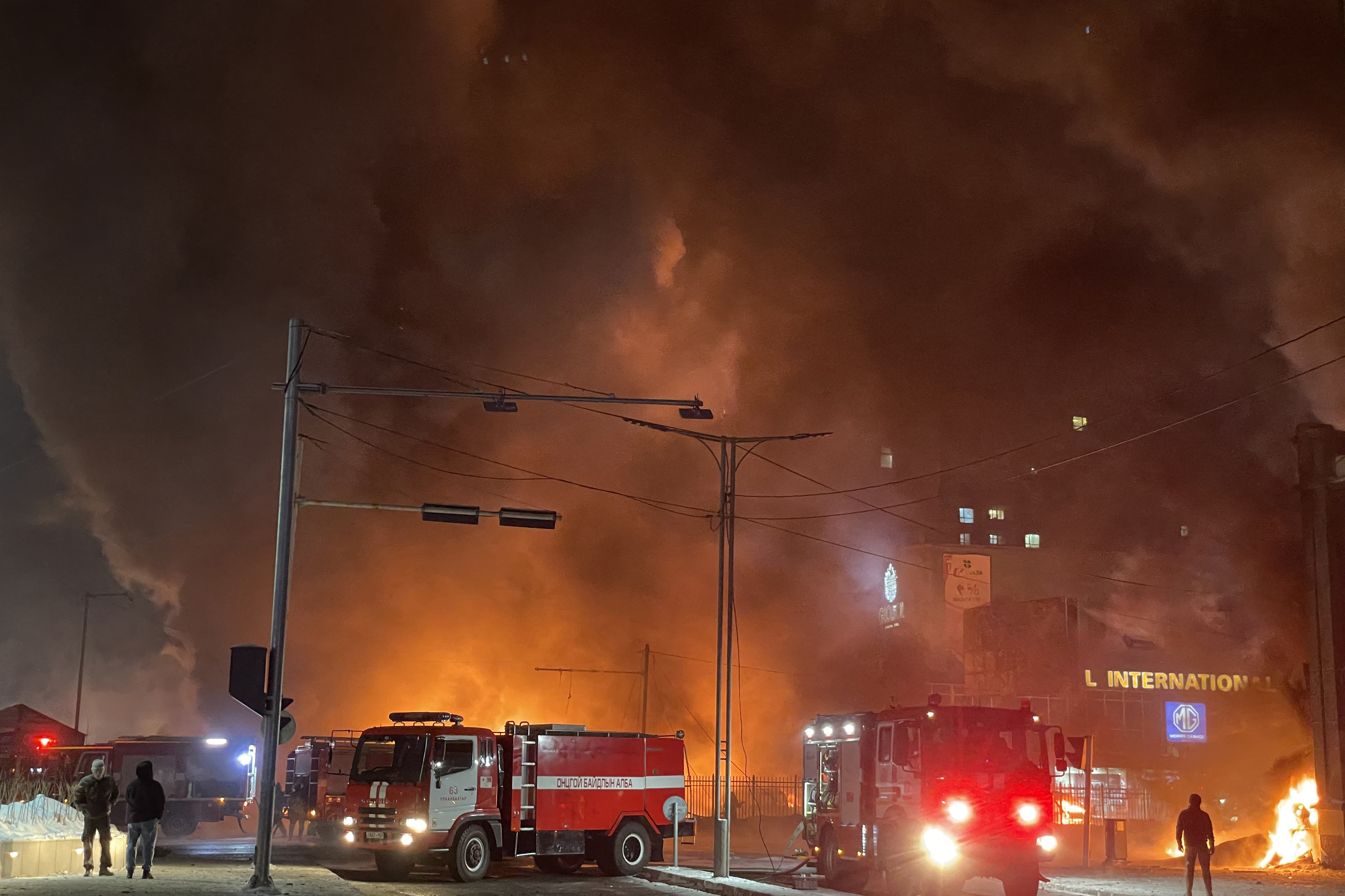 Firefighters work at the scene of an explosion from a vehicle crash in Ulaanbaatar, the capital of Mongolia on January 24, 2024