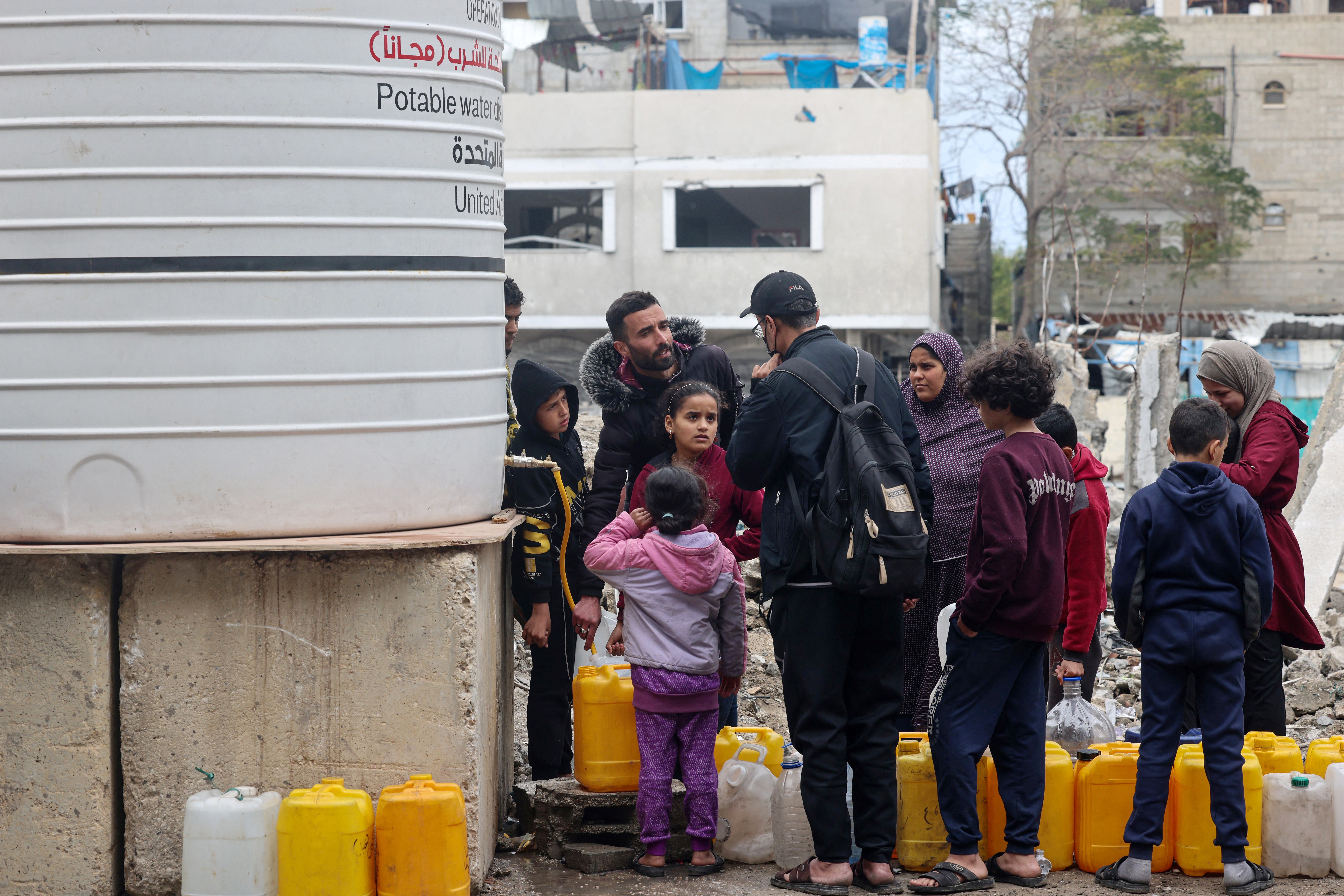 people line up with yellow water bottles