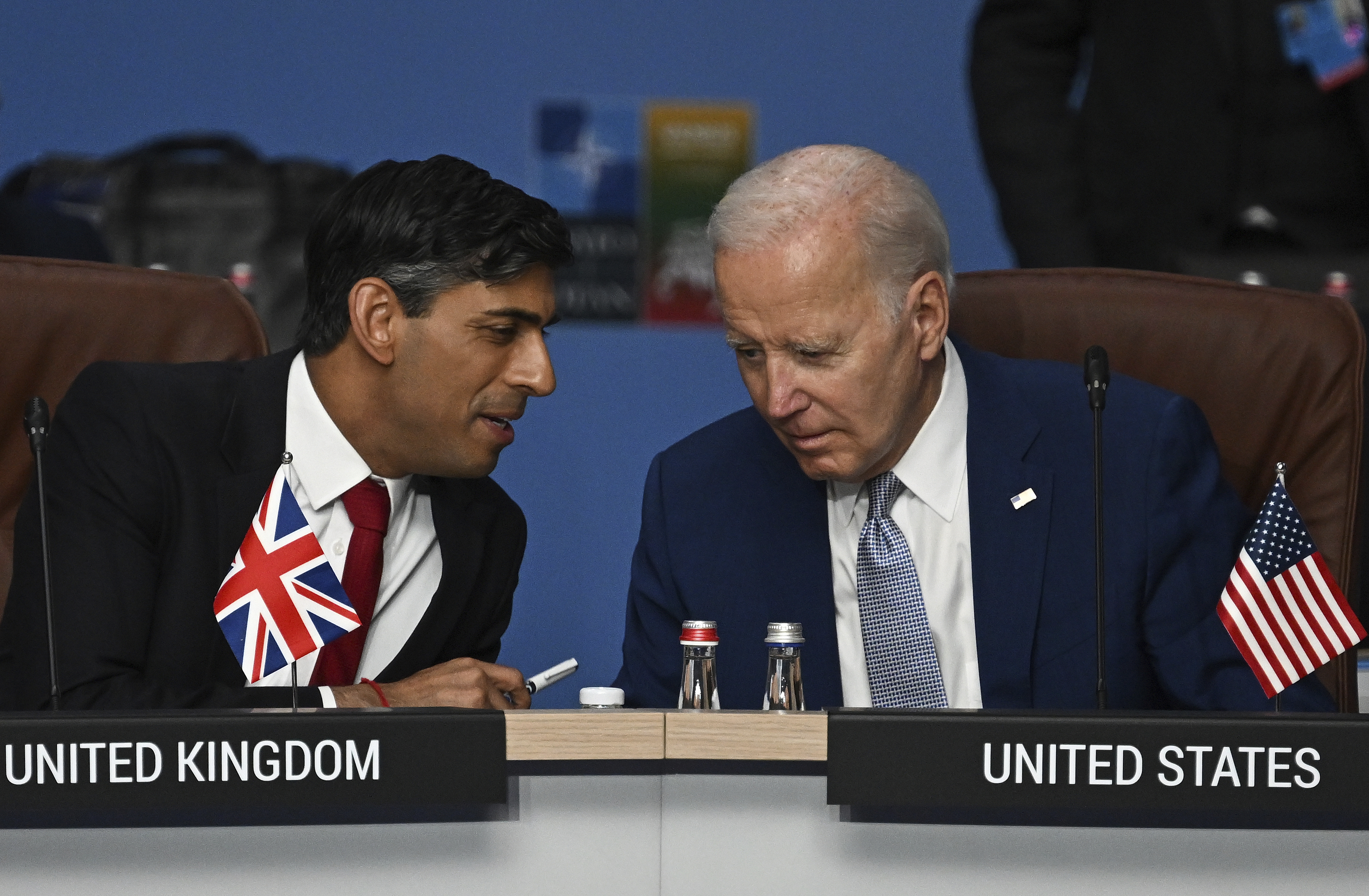 Britain's Prime Minister Rishi Sunak, left, and U.S. President Joe Biden speak at the start of the meeting of the North Atlantic Council (NAC) during the NATO Summit in Vilnius, Lithuania, July 11, 2023.