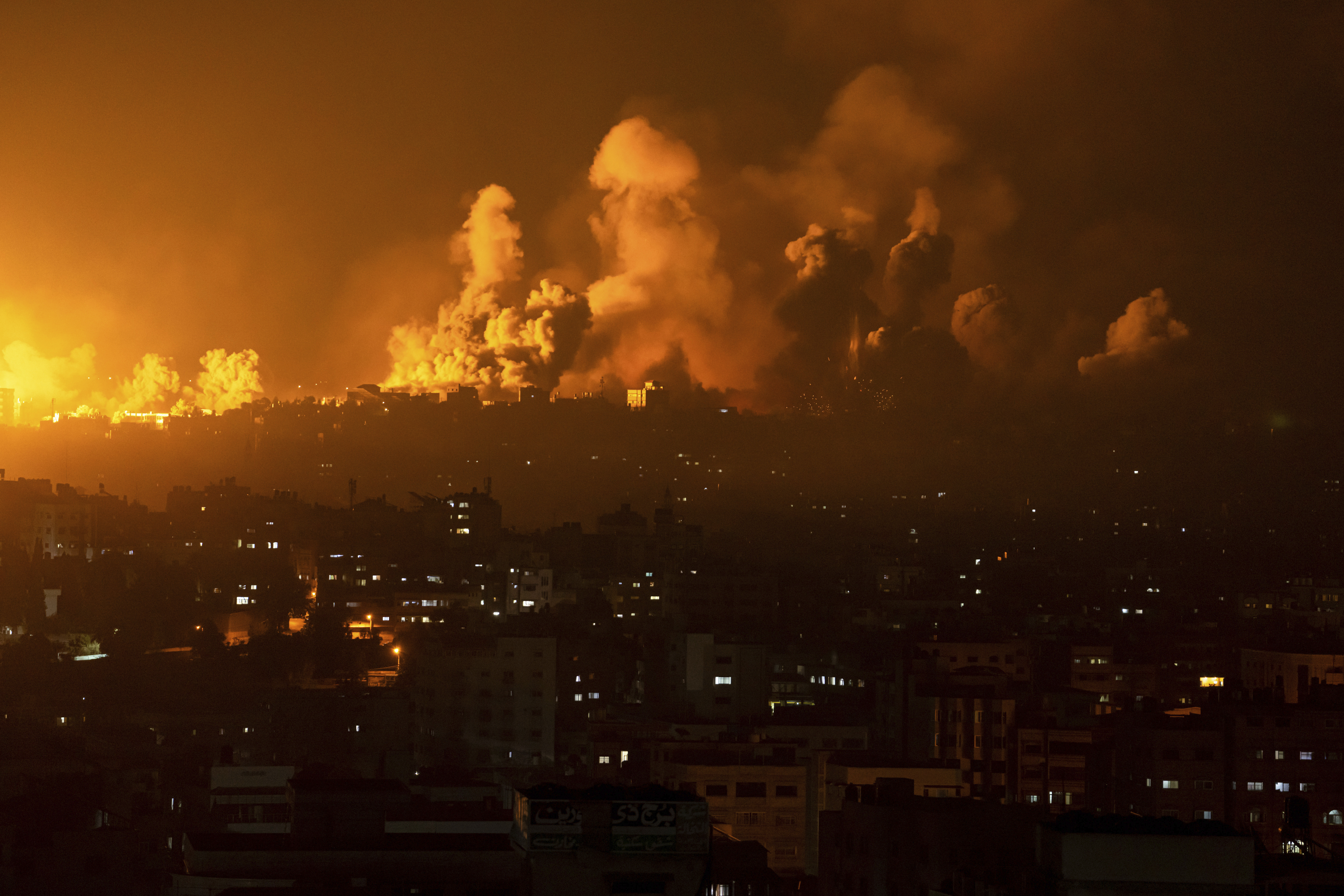 Fire and smoke rise following an Israeli airstrike, in Gaza City, Sunday, Oct. 8
