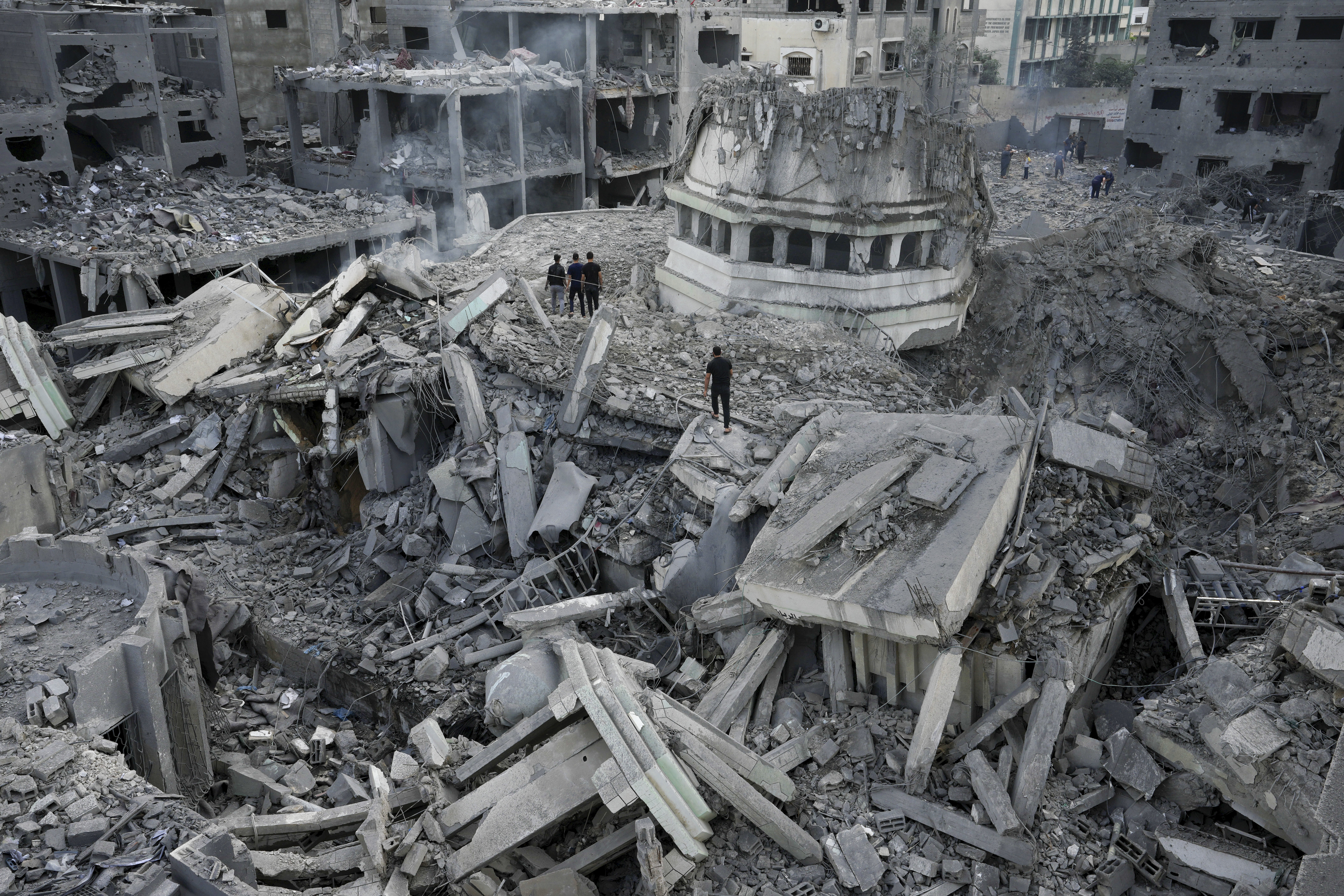 Palestinians inspect the rubble of the Yassin Mosque destroyed after it was hit by an Israeli airstrike at Shati refugee camp in Gaza City, early Monday, Oct. 9