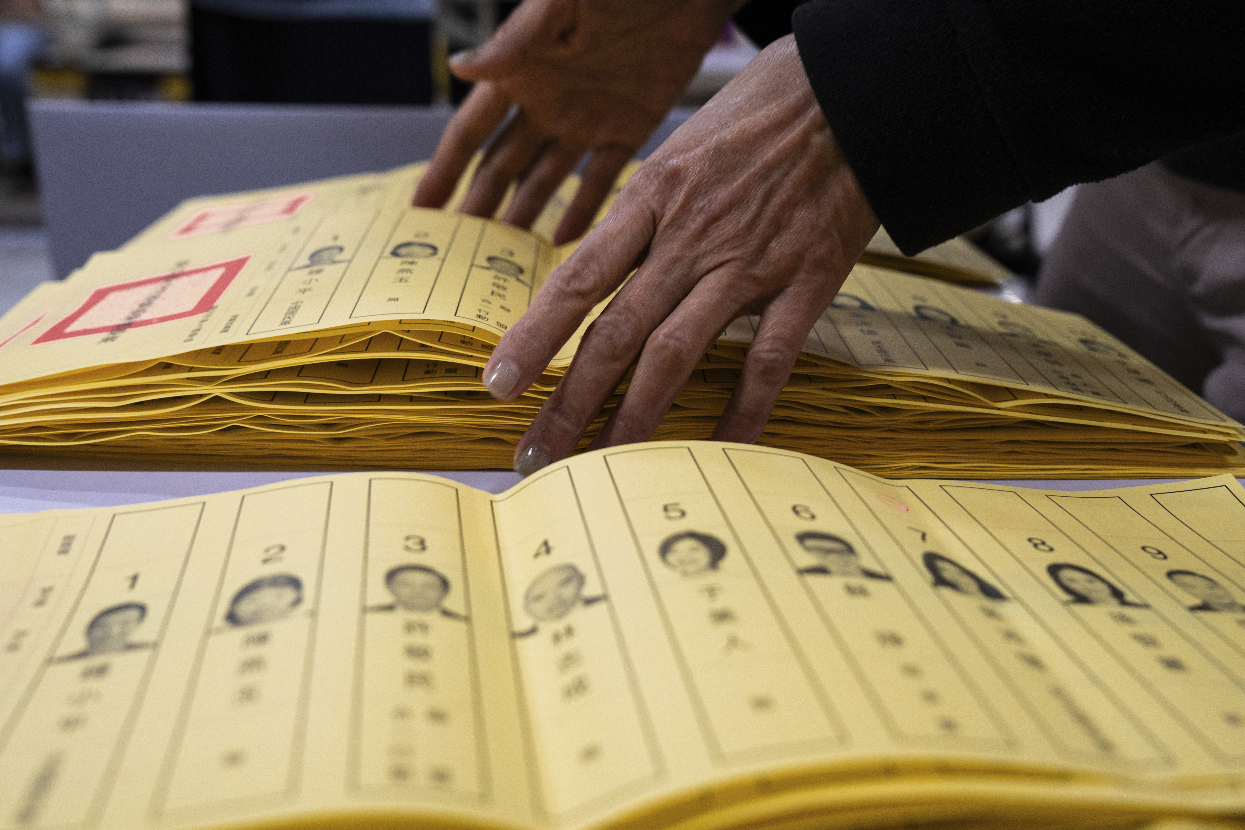 Staff count votes at a polling station in Taipei, Taiwan, Saturday, Jan. 13,