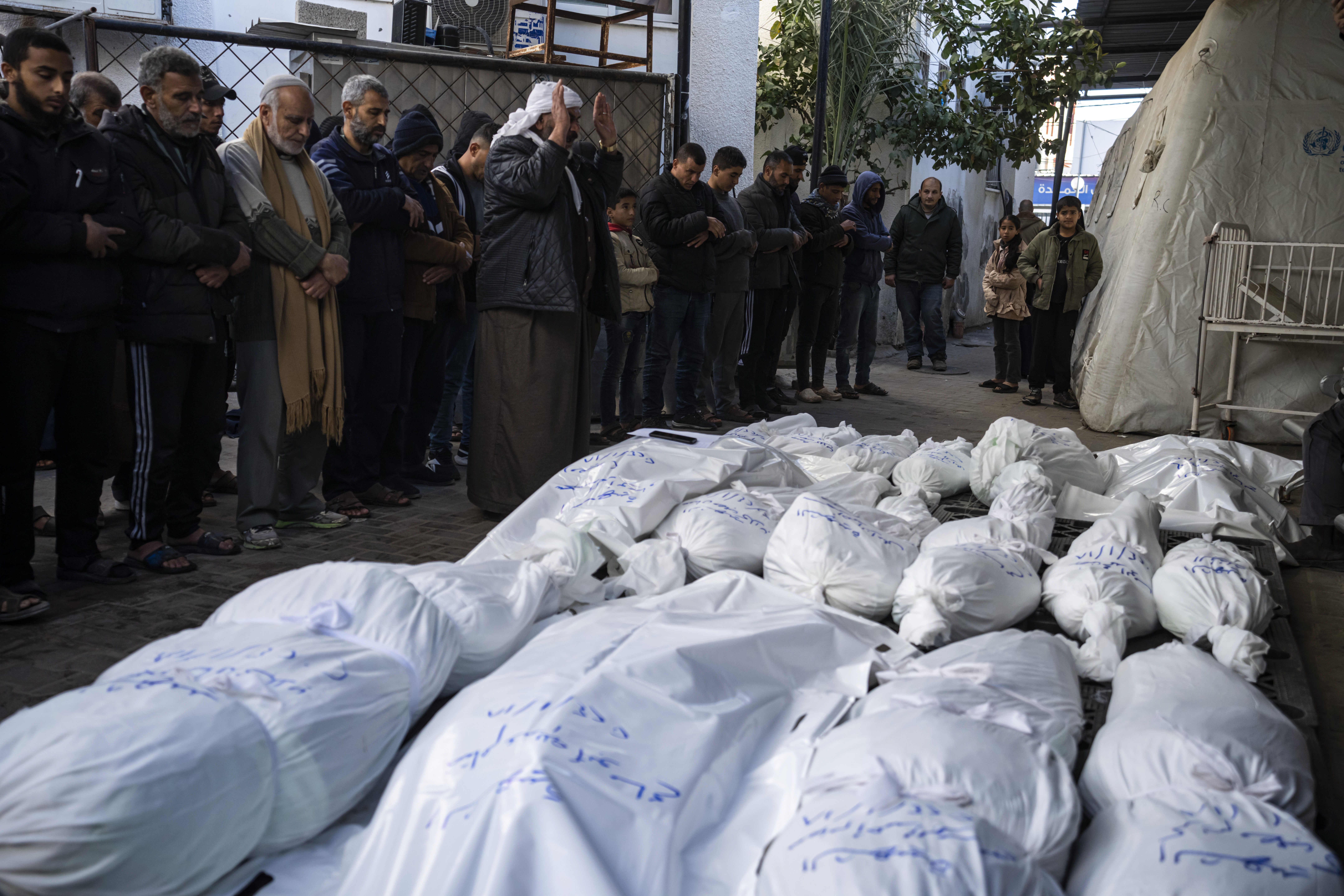 Palestinians mourn their relatives killed in the Israeli bombardment of the Gaza Strip, outside a morgue in Rafah, southern Gaza