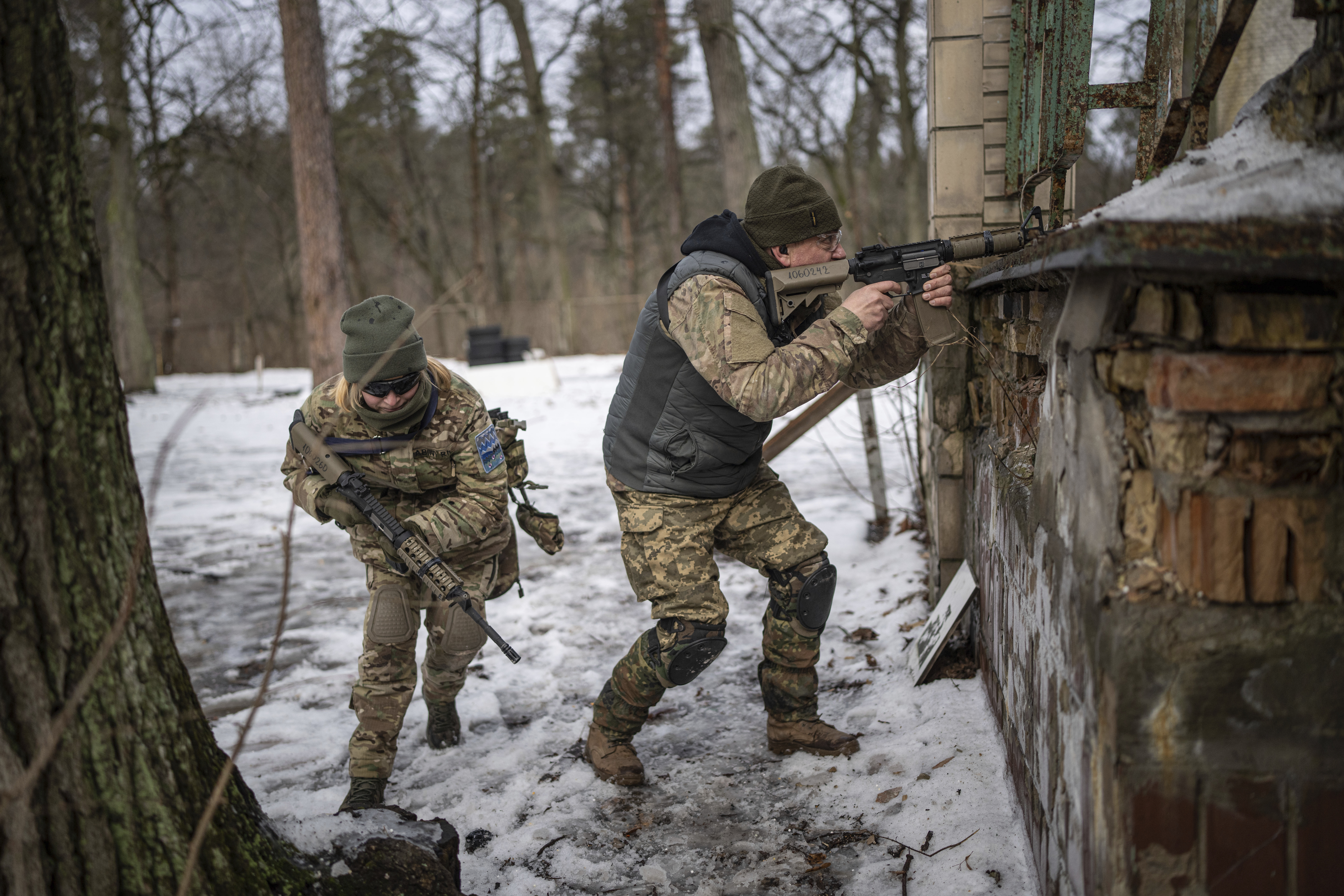 People practise combat skills in urban areas during a training course for national resistance of the Municipal Guard near Kyiv, Ukraine