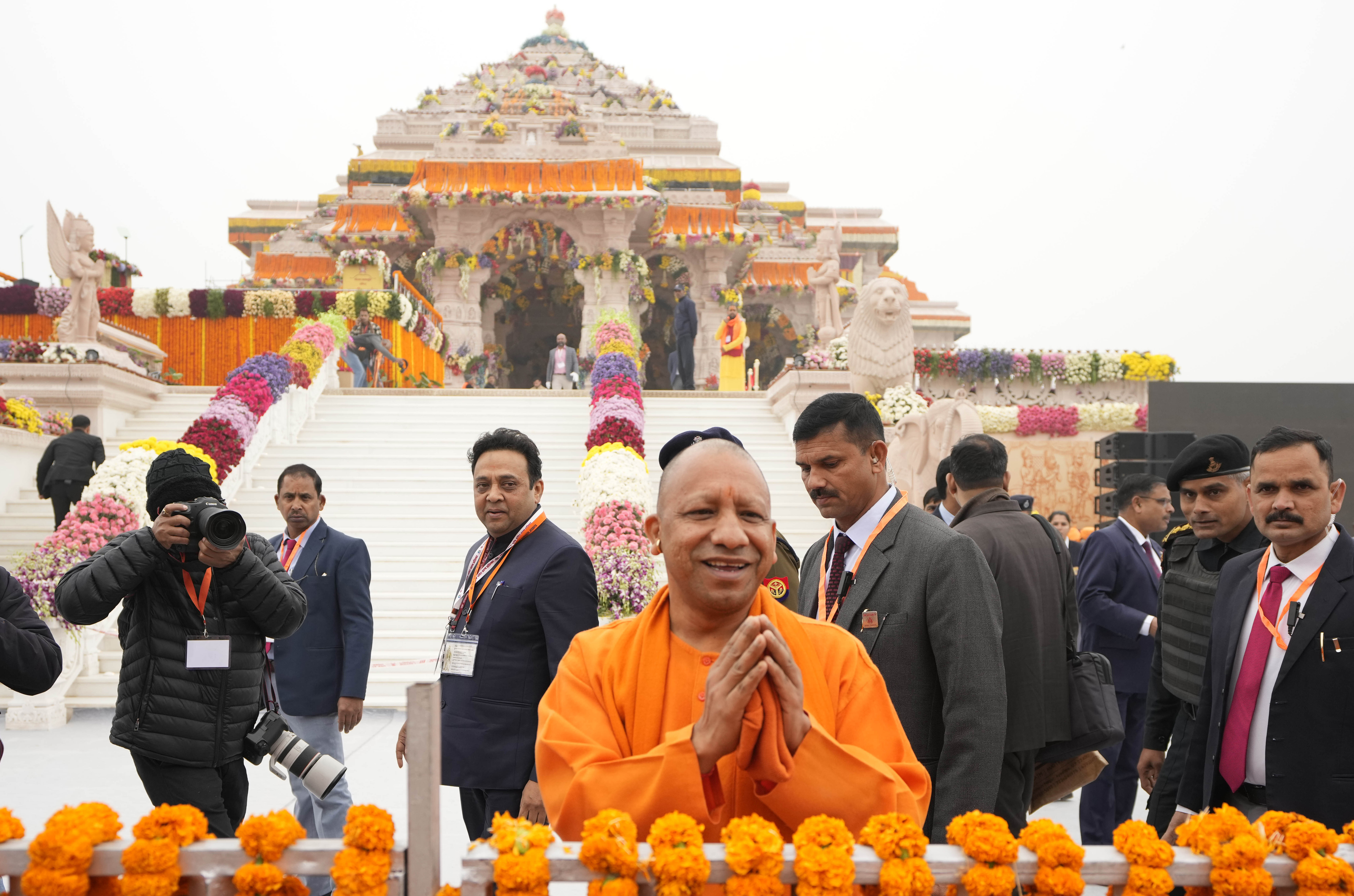 Uttar Pradesh Chief Minister Yogi Adityanath, center, greets people ahead of the inauguration of the temple of the Hindu god Ram in Ayodhya