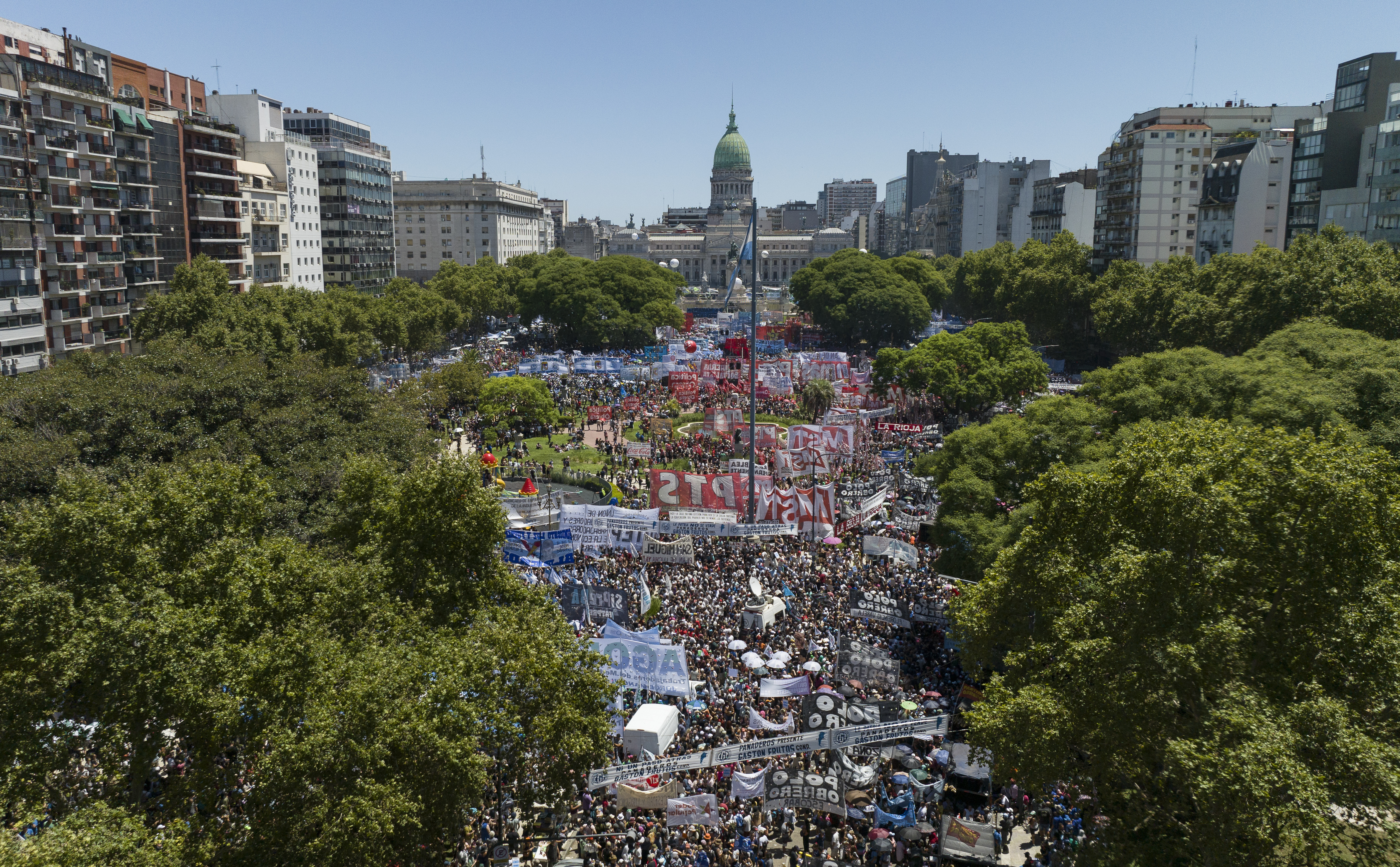 An aerial view of the plaza in front of Argentina's domed congress building. Lined by trees, the plaza is packed with protesters.