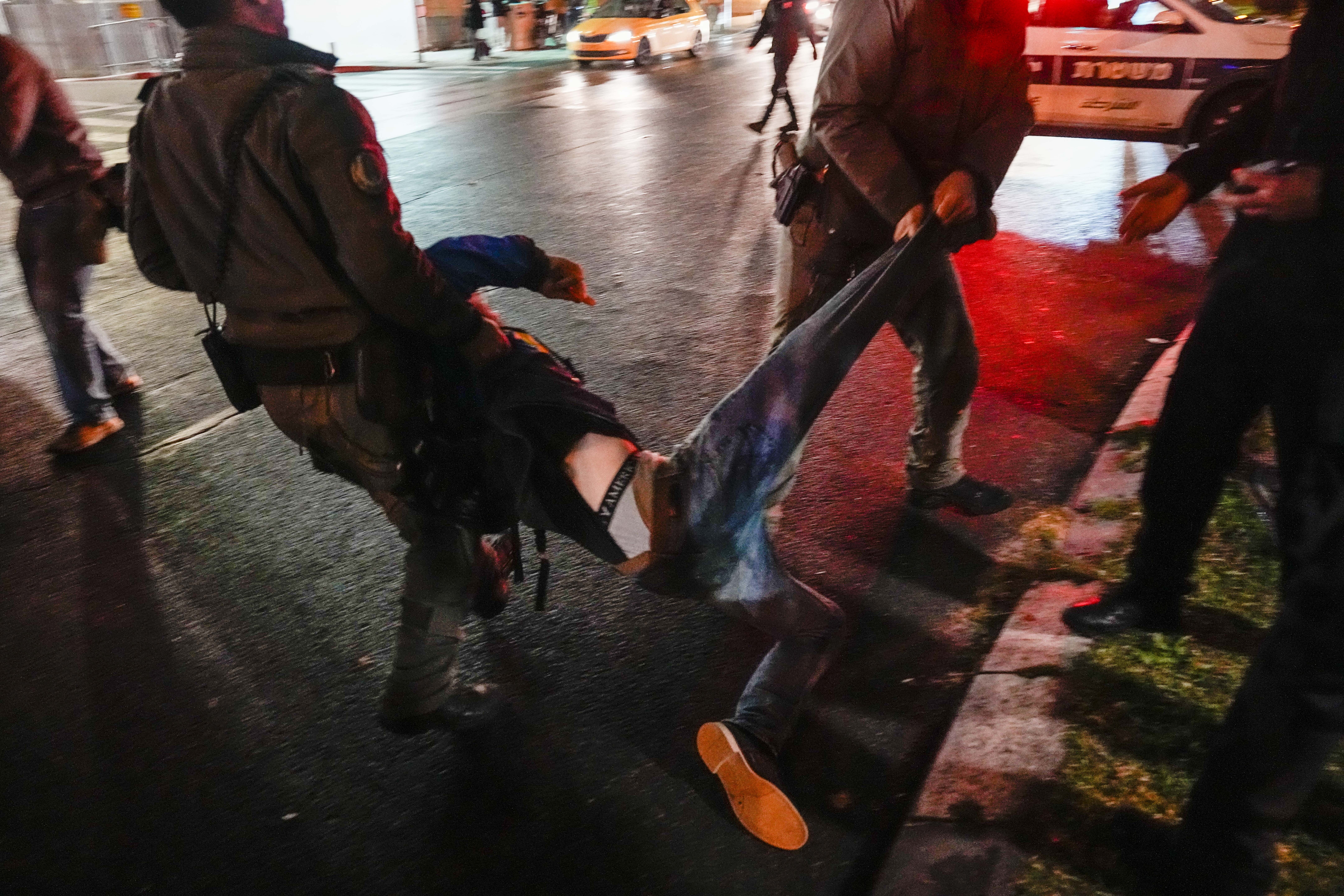 Israeli police detain a man during a demonstration calling for new elections, frustrated with the government's failure to bring all hostages held in the Gaza Strip by the Hamas militant group and demanding a ceasfire in Tel Aviv, Israel, Saturday, Jan. 27