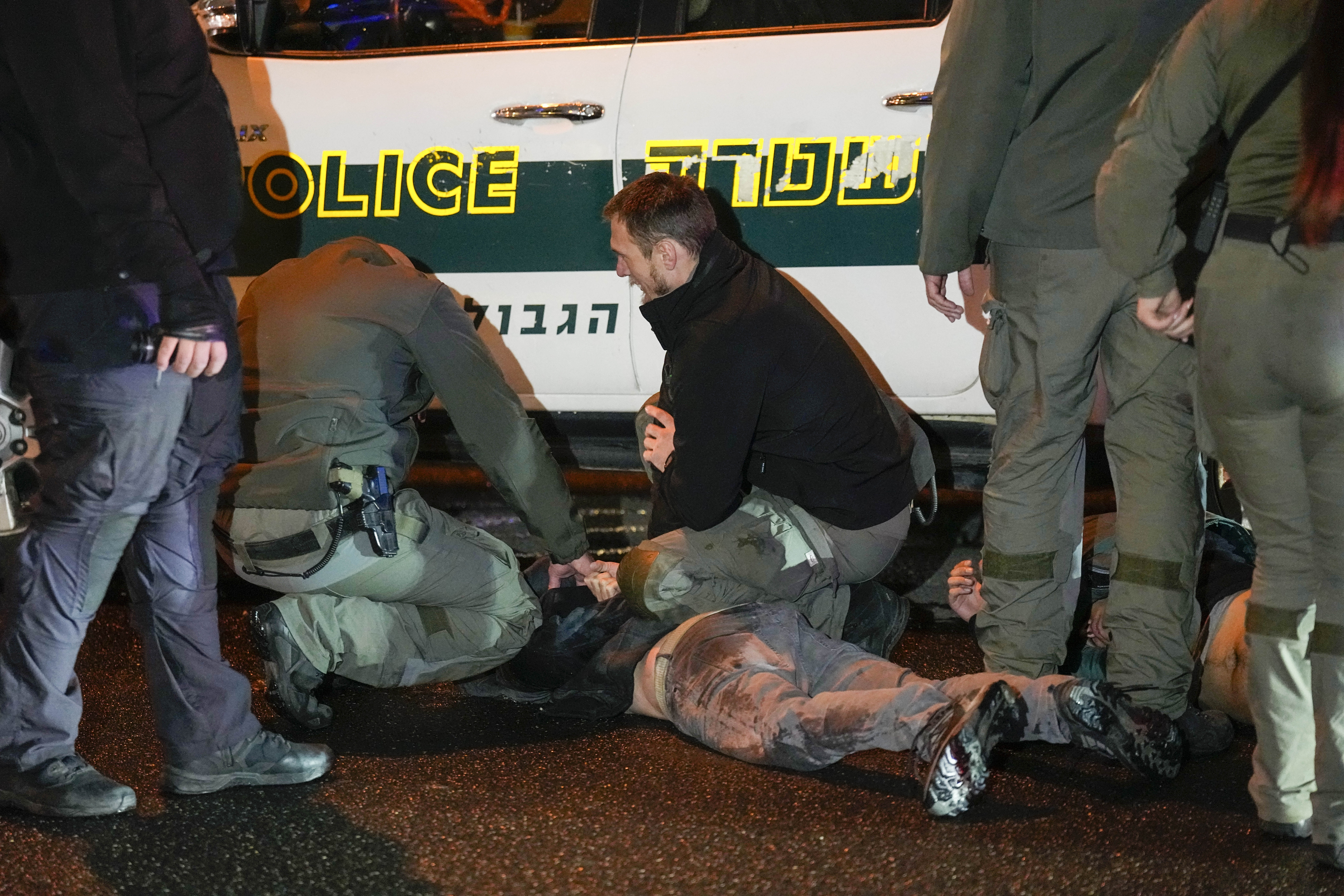 Israeli police detain a man during a demonstration calling for new elections, frustrated with the government's failure to bring all hostages held in the Gaza Strip by the Hamas militant group and demanding a ceasfire in Tel Aviv