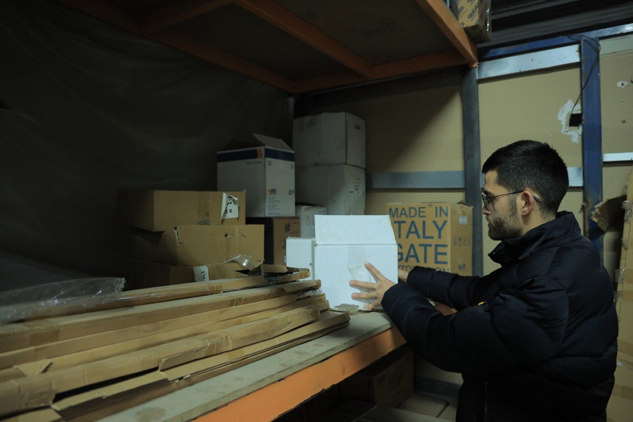 Mohamed Nairoukh moves boxes on stock shelves