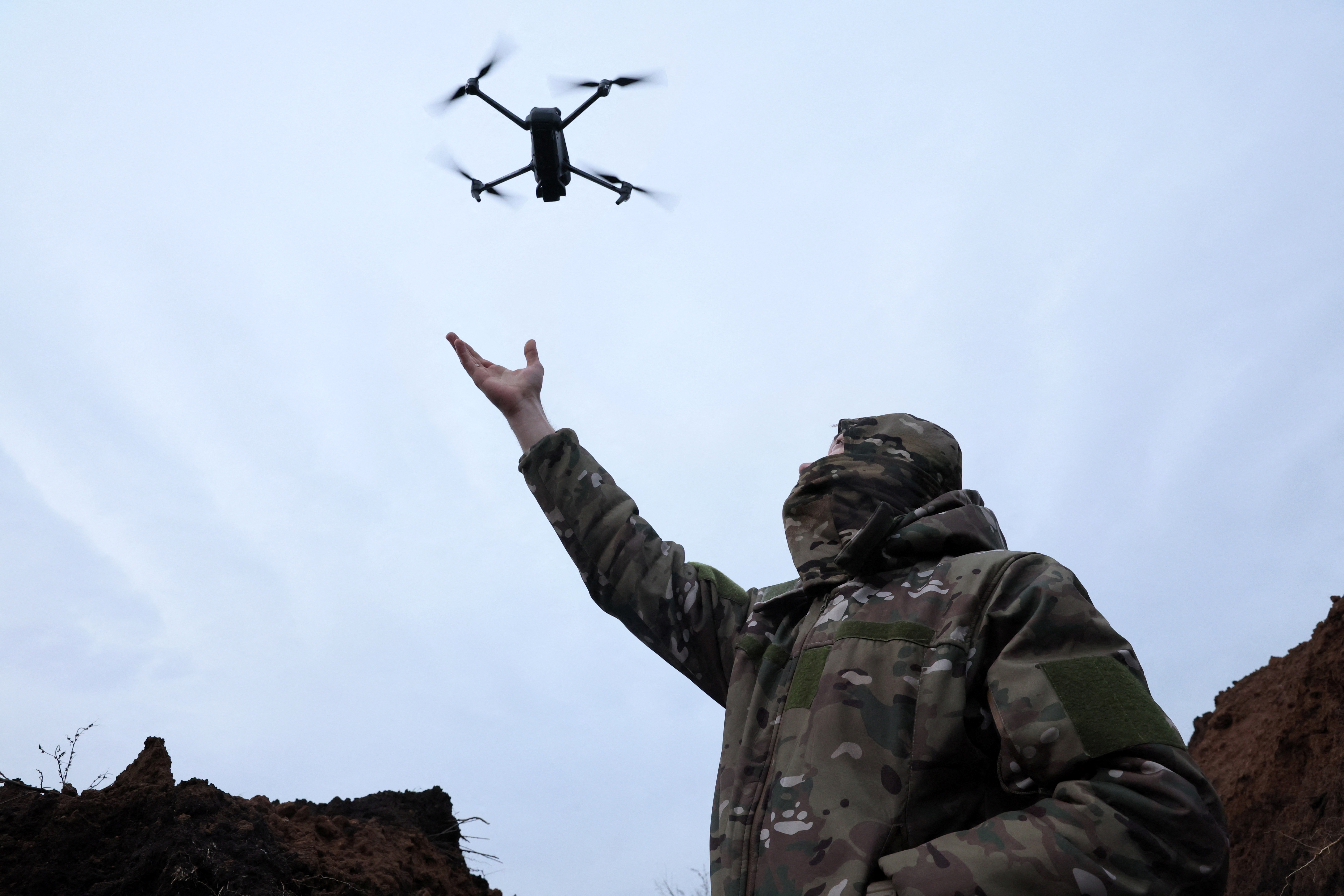 "Soap", 30, a soldier with the 58th Independent Motorized Infantry Brigade of the Ukrainian Army catches a drone while testing it, as Russia's invasion of Ukraine continues, near Bakhmut, Ukraine, November 25, 2022. REUTERS/Leah Millis