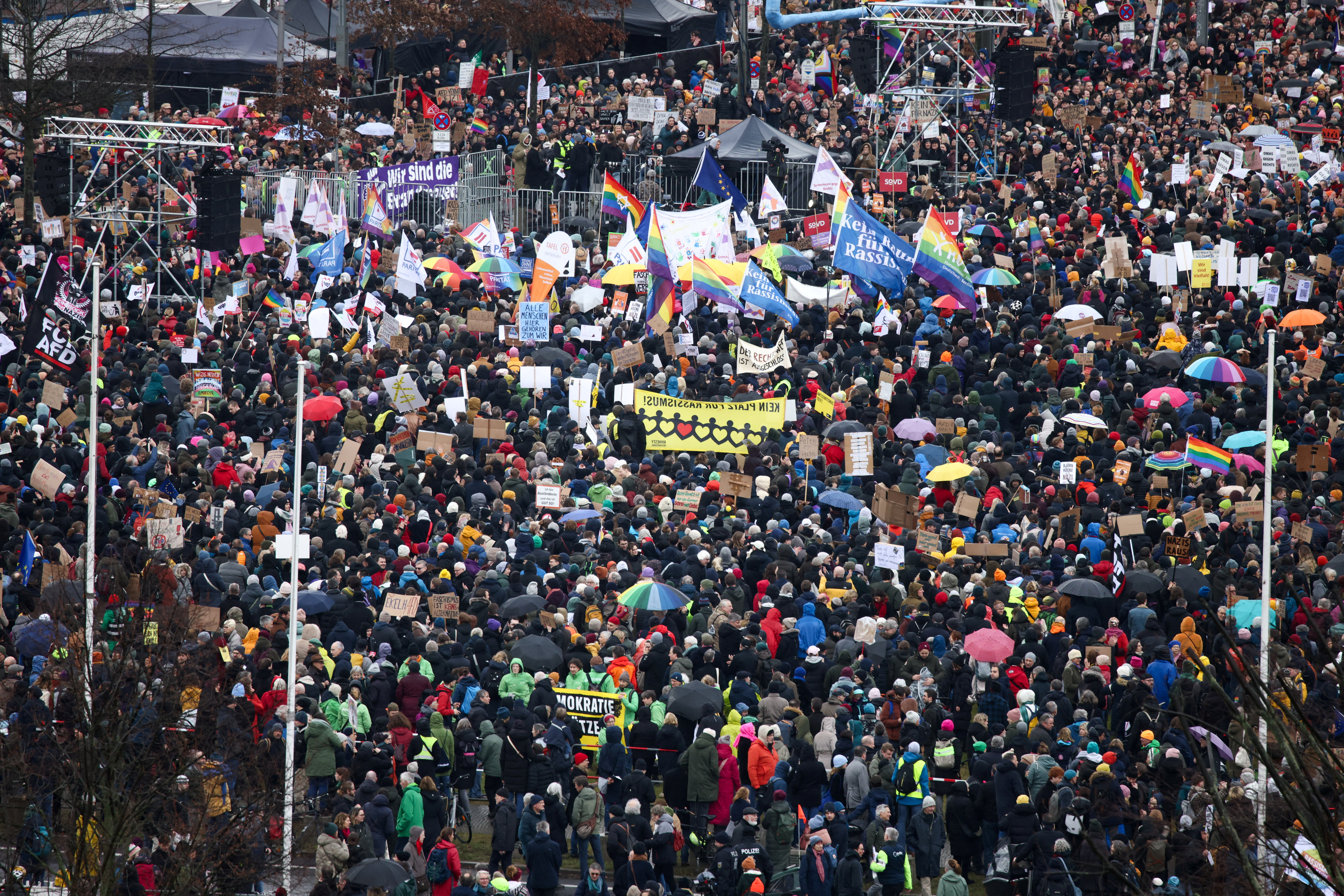 People gather outside the Reichstag building, during a rally of the broad alliance "Hand in Hand" under the slogan "Wir sind die Brandmauer" ("We are the Firewall") to protest against right-wing extremism and for the protection of democracy, in Berlin, Germany February 3