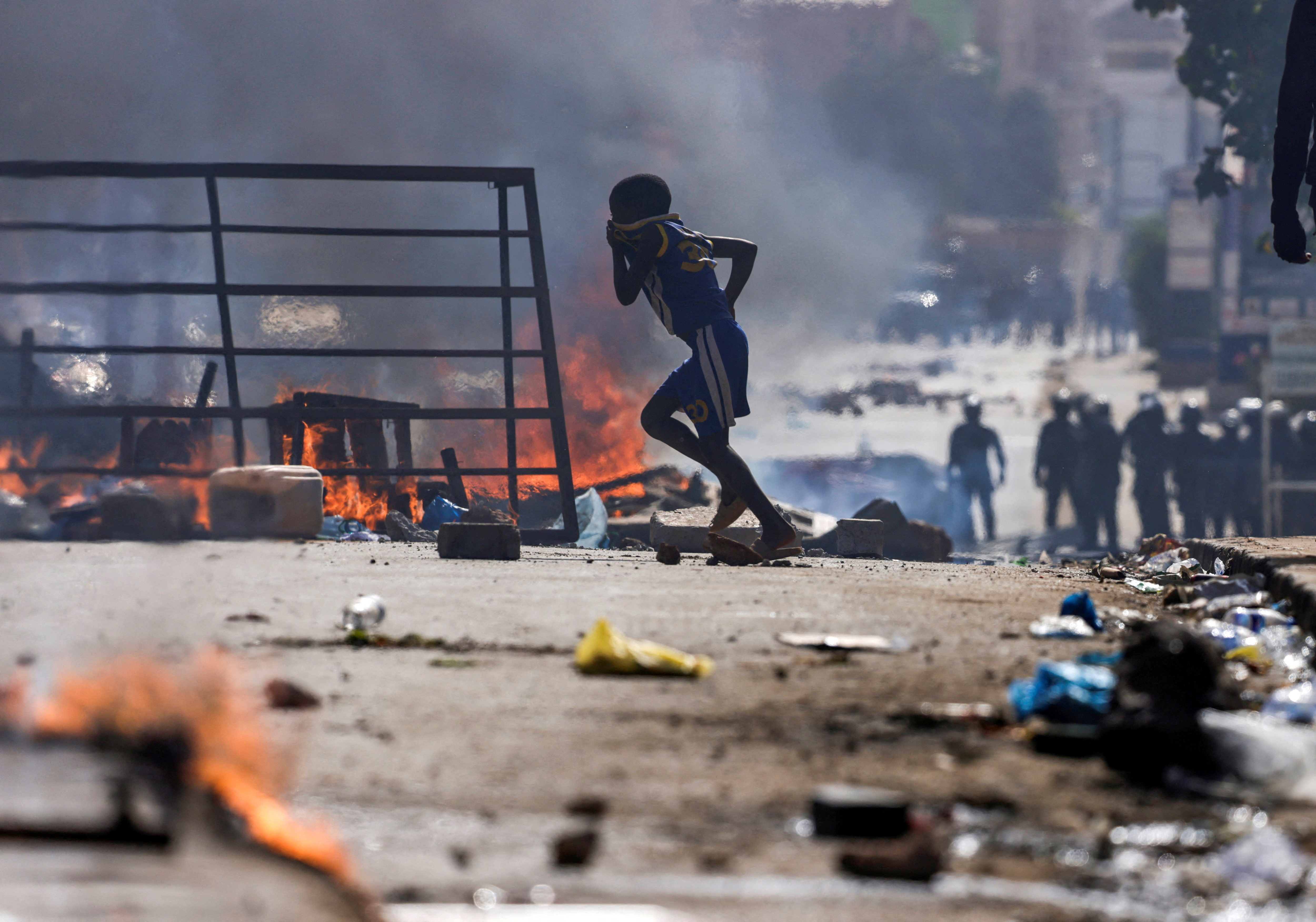 A boy runs past barricades as Senegalese demonstrators clash with riot police during a protest against the postponement of the Feb. 25 presidential election, in Dakar, Senegal February 4, 2024. REUTERS/Zohra Bensemra TPX IMAGES OF THE DAY