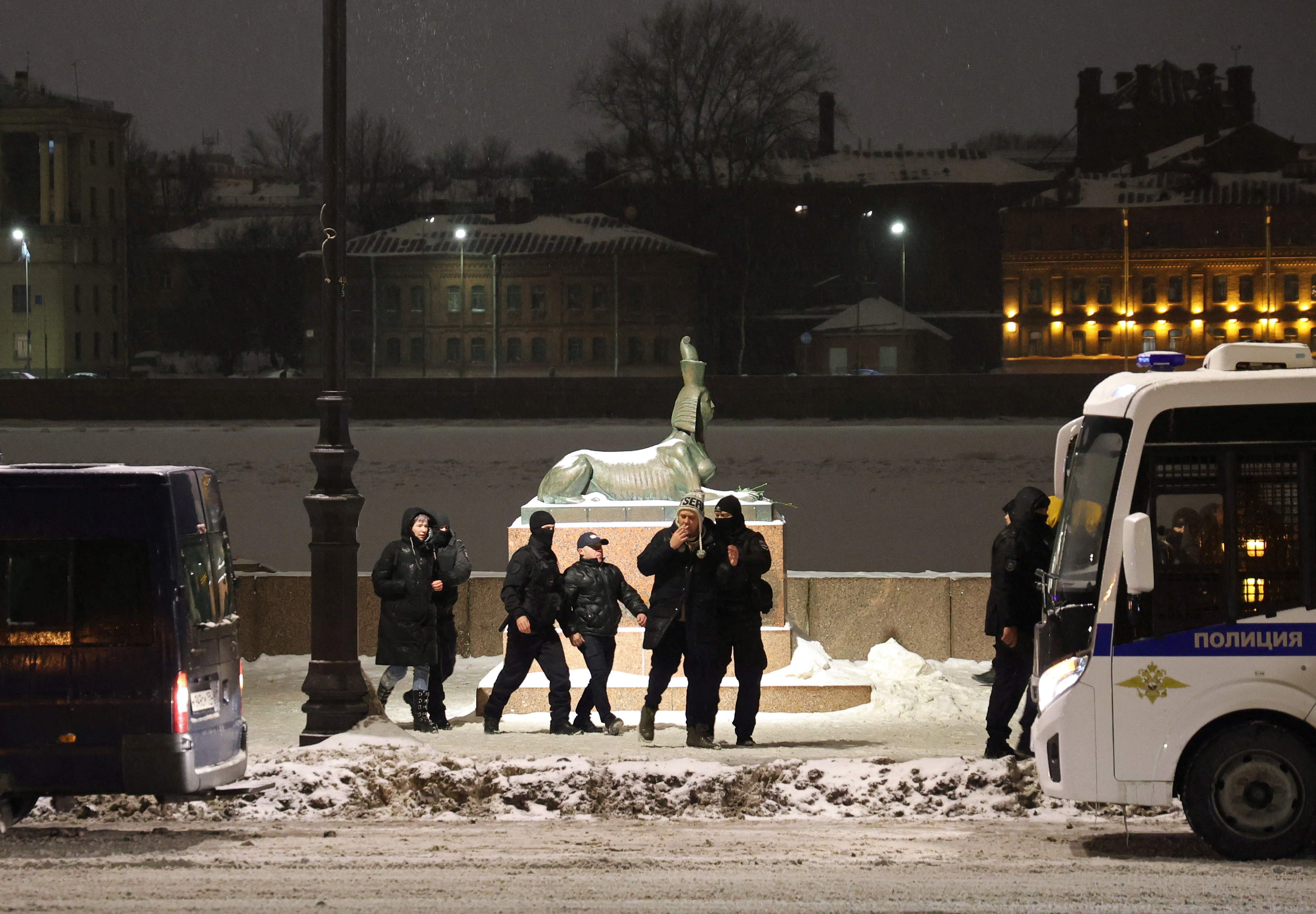 Law enforcement officers lead activists to a police van during a vigil in memory of Russian opposition leader Alexei Navalny in Saint Petersburg, Russia February 16, 2024. REUTERS/Stringer