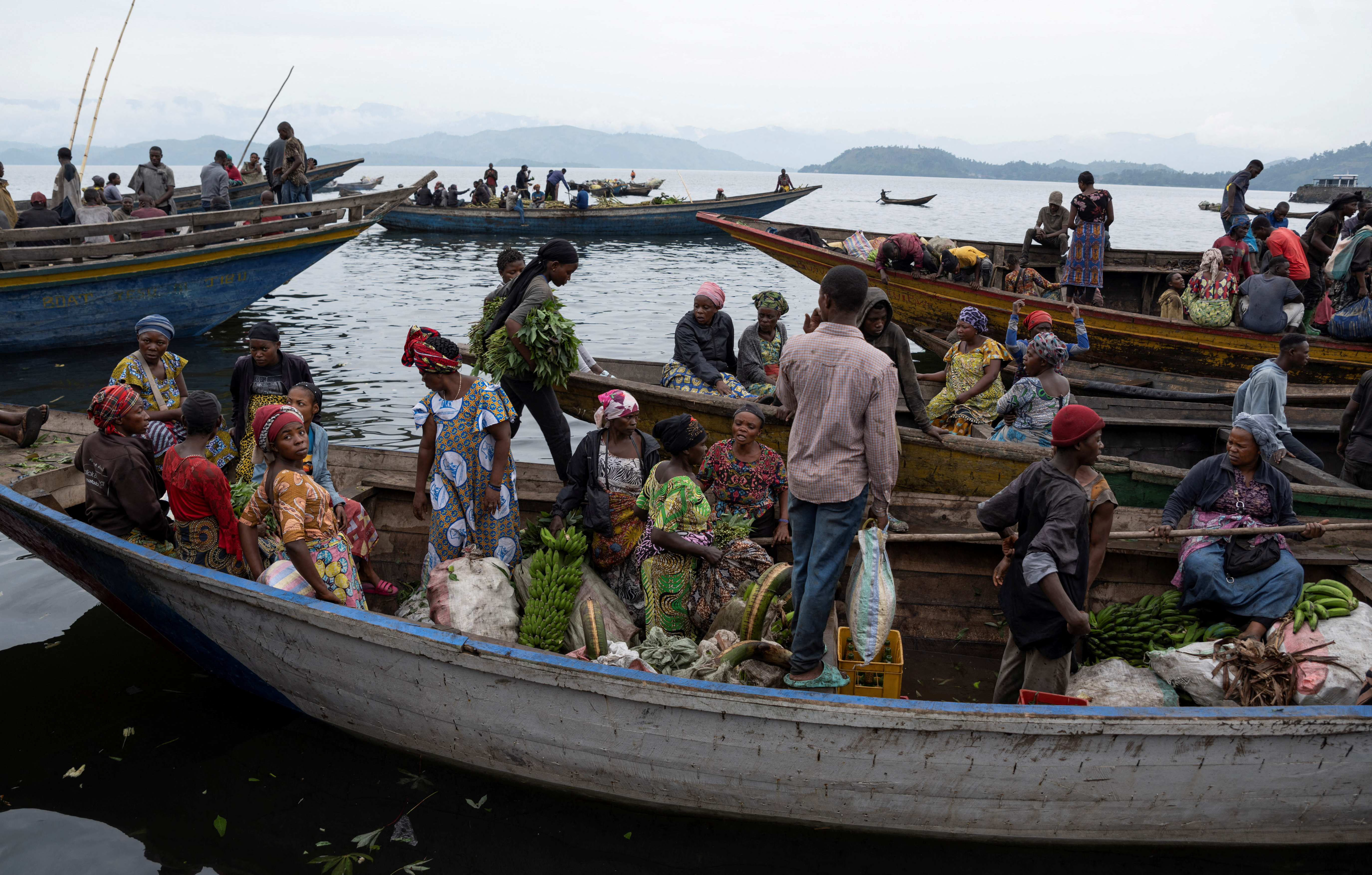 Congolese traders off load goods from pirogues carrying food from Minova village, after the roads were blocked due to the ongoing war between the M23 rebels and the Congolese army, at the Kituku market in Goma, North Kivu province of the Democratic Republic of Congo February 15, 2024.