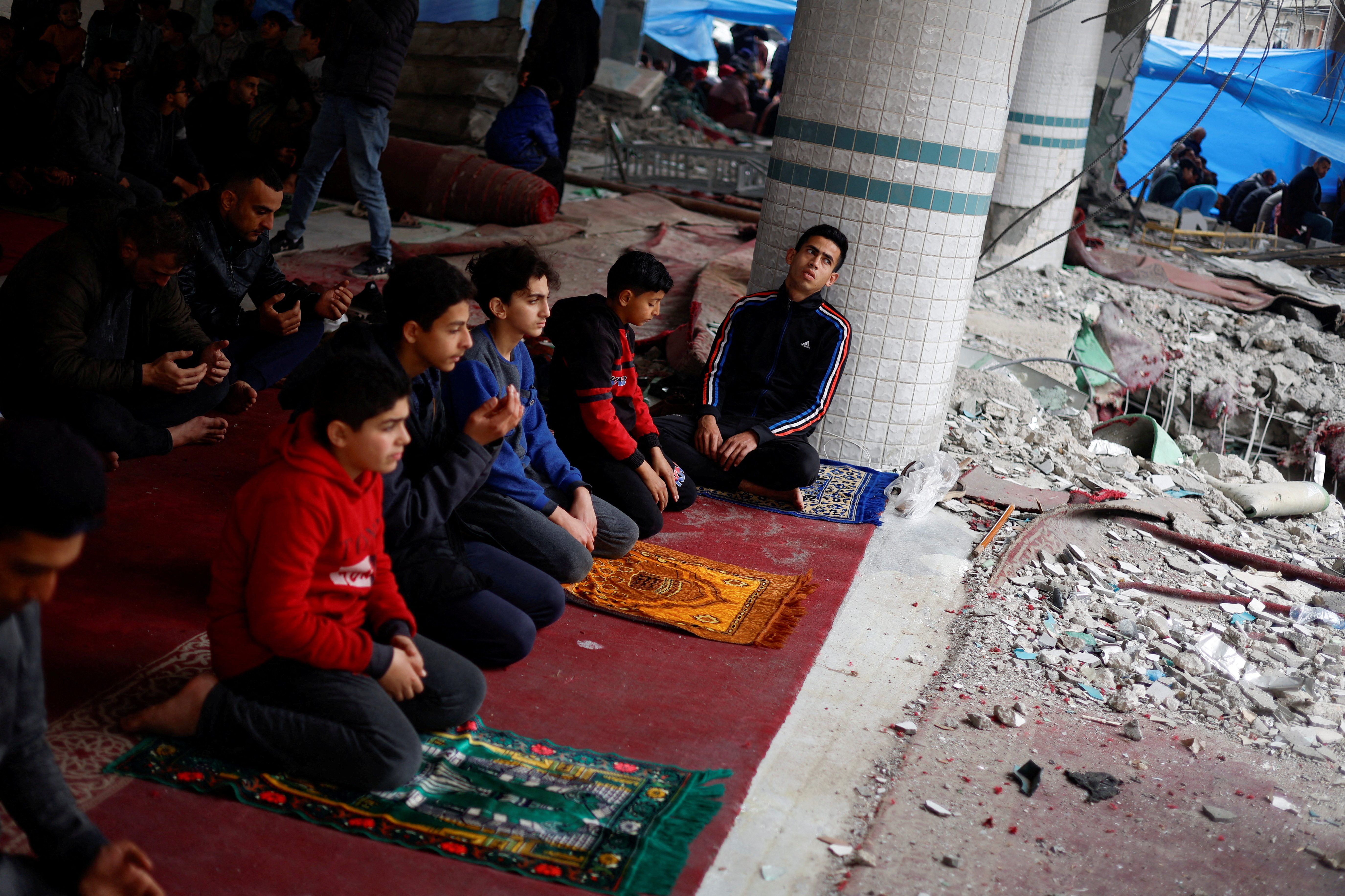 Palestinians perform Friday prayers at the ruins of a mosque destroyed in Israeli strikes, amid the ongoing conflict between Israel and the Palestinian Islamist group Hamas, in Rafah in the southern Gaza Strip February 23,