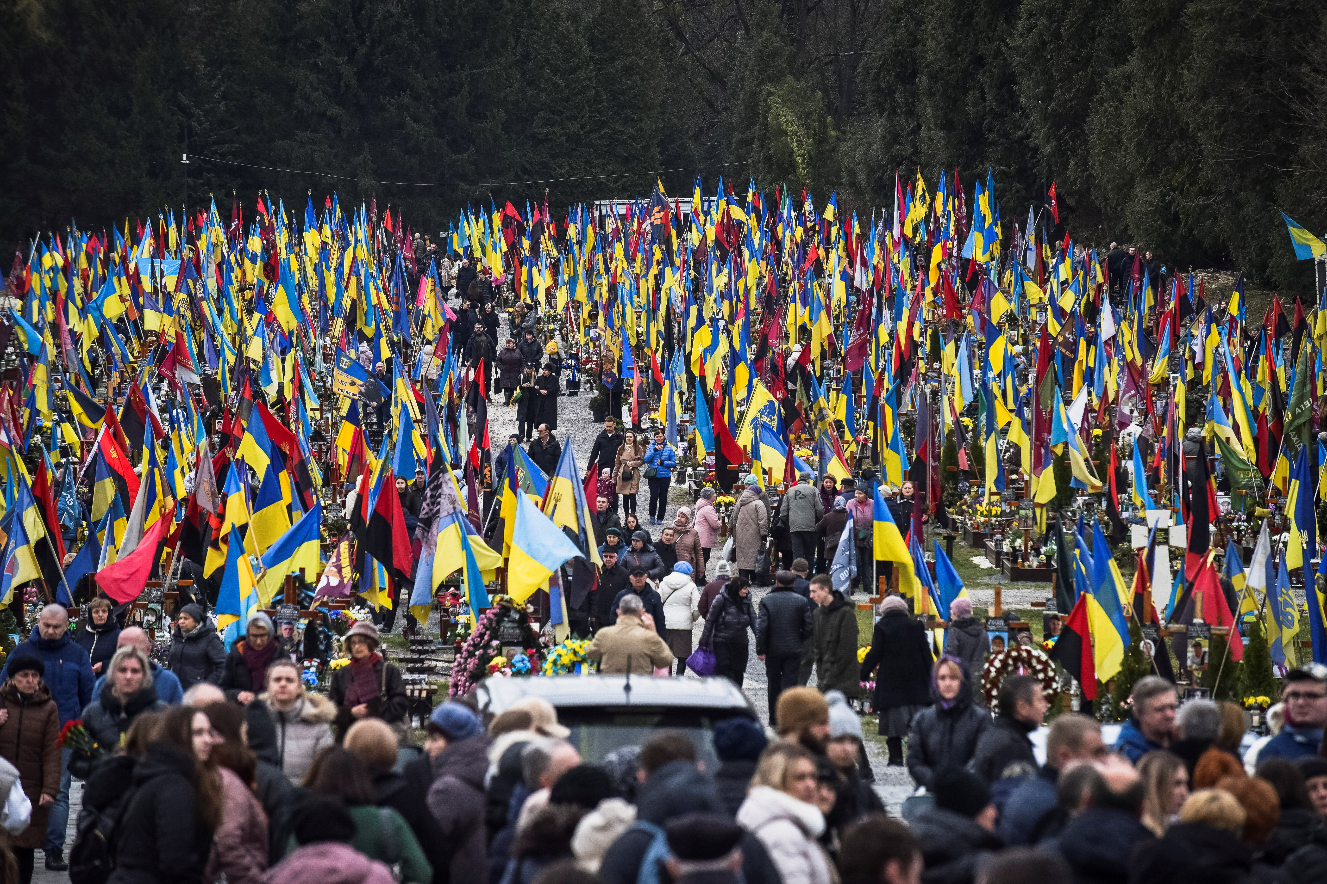 People visit graves of their relatives, killed Ukrainian defenders, on a day of the second anniversary of Russia's attack on Ukraine, in Lviv, Ukraine February 24