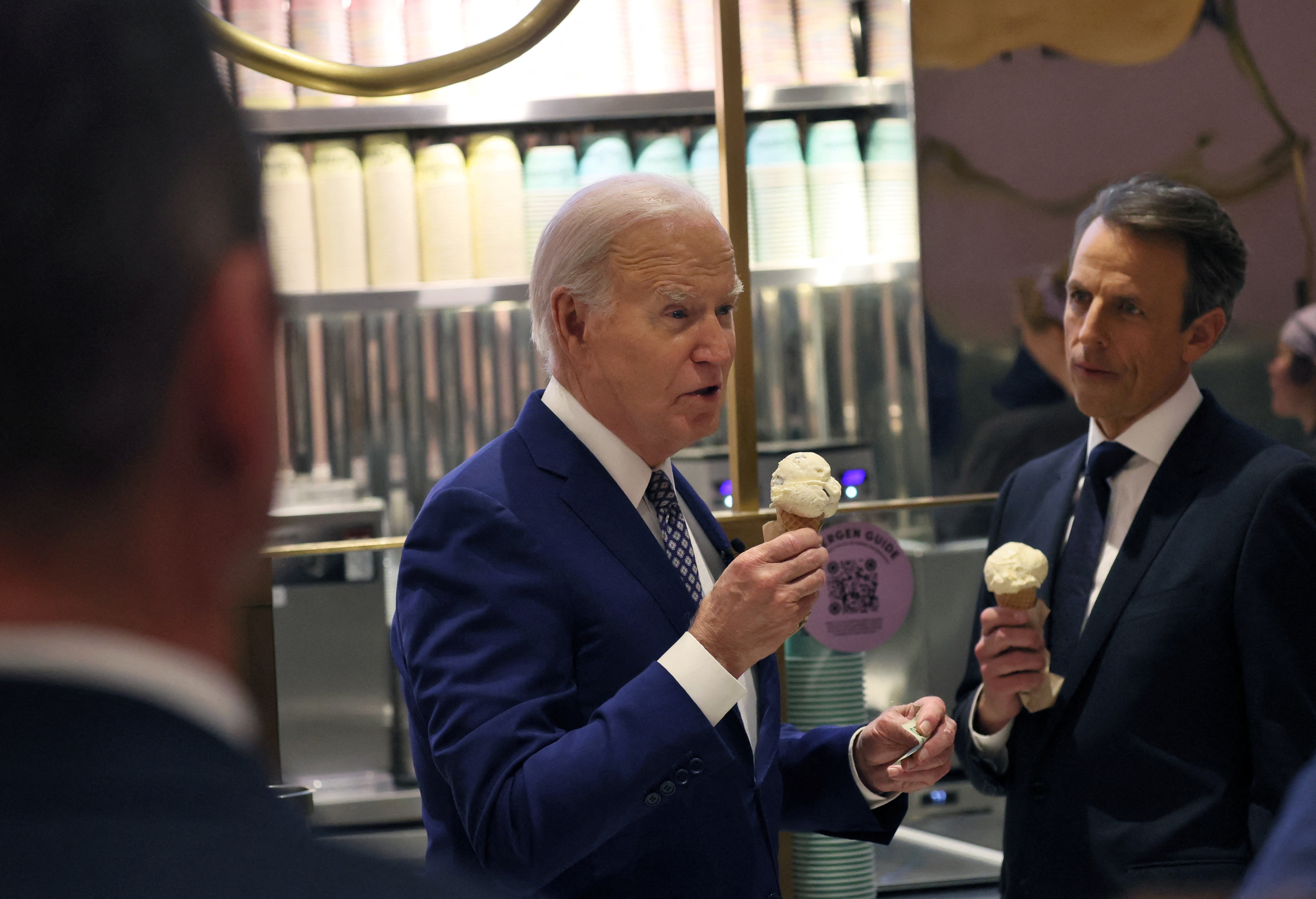 President Joe Biden answers a question from a journalist as he visits an ice cream shop in downtown New York