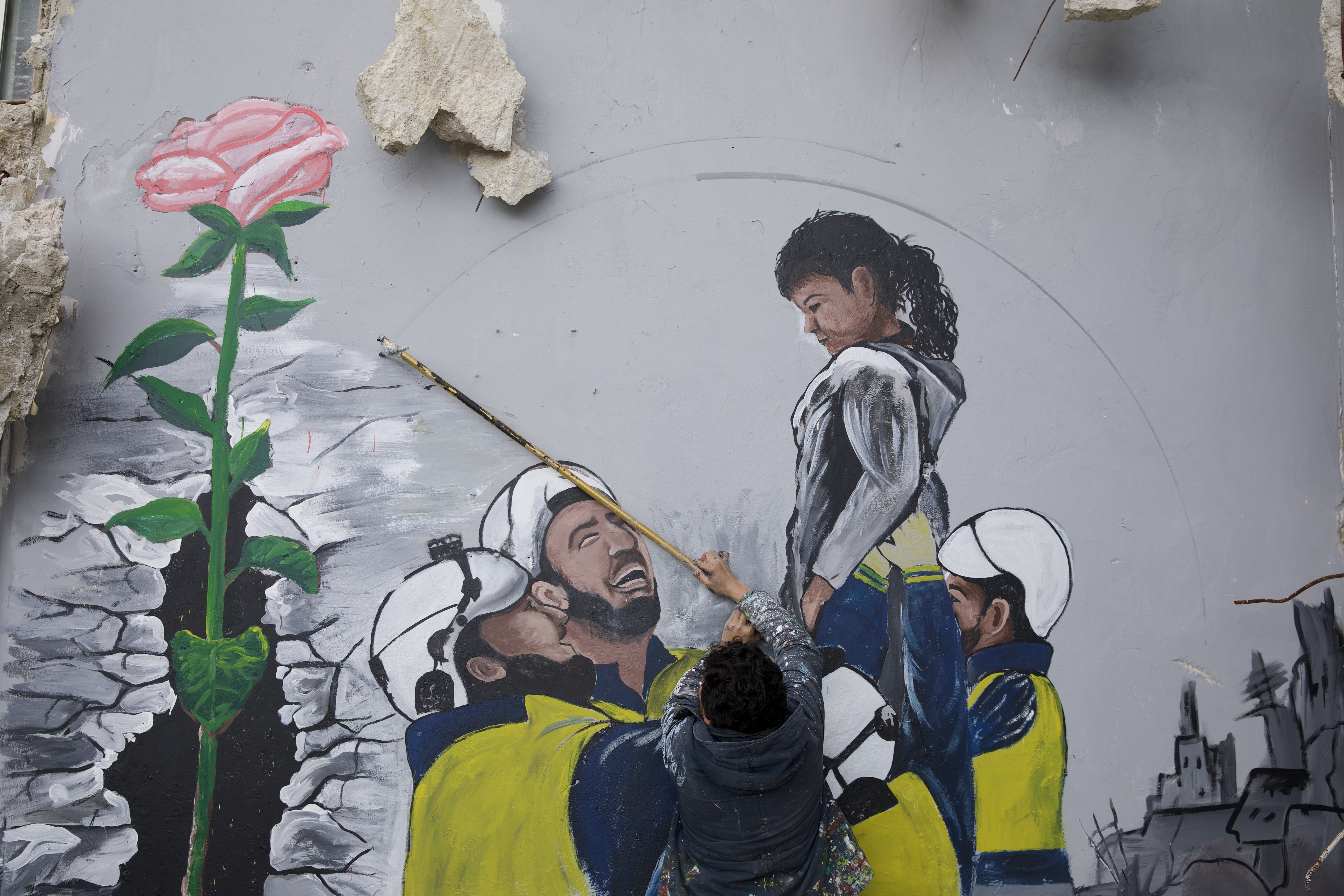 A mural showing civil defense teams (White Helmets) rescuing a girl from under the rubble after the earthquake in northwestern Syria.