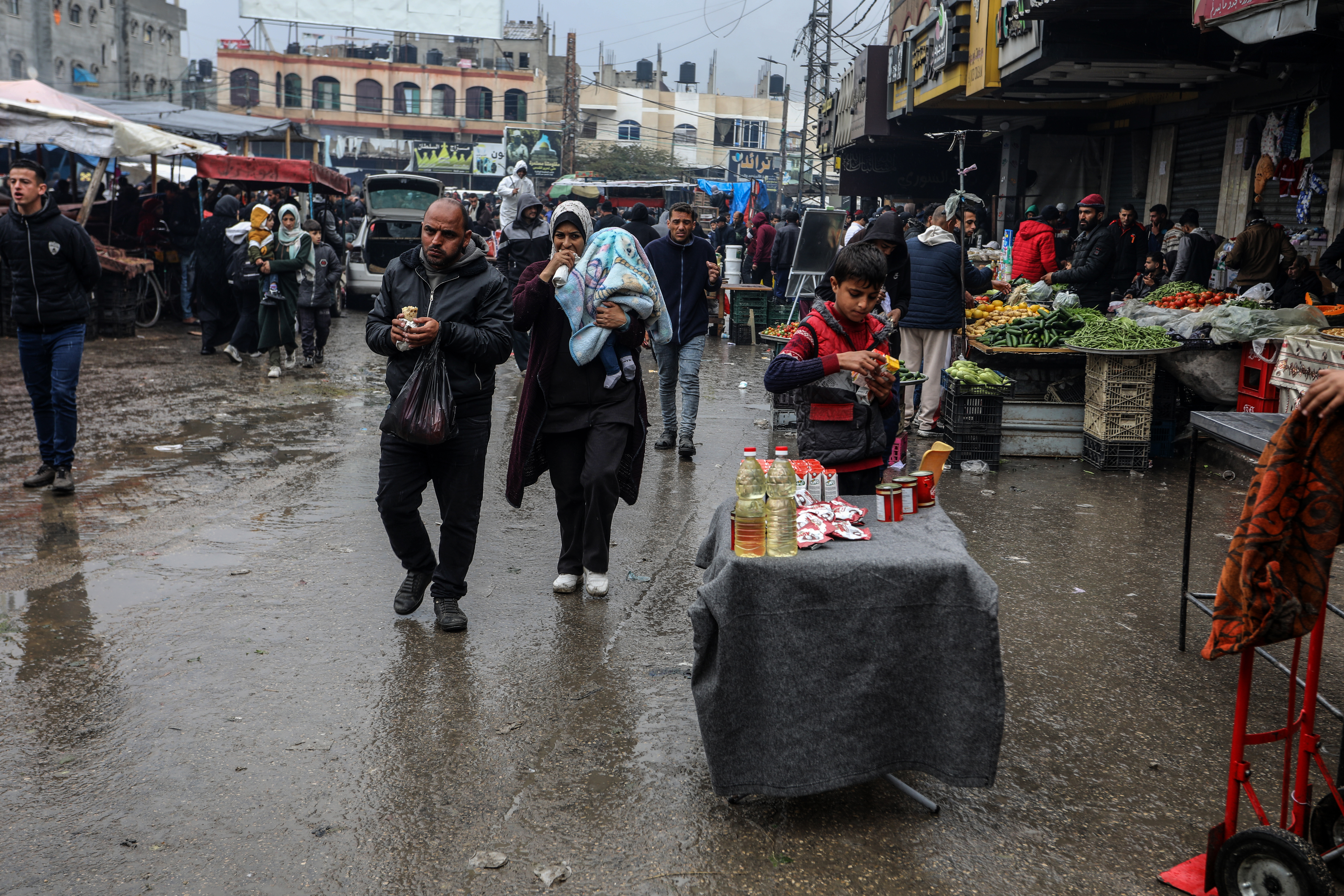 Palestinians flock to bazaars to meet their needs during rainy day as they try to continue their daily life amid Israeli attacks in Rafah, Gaza on February 18
