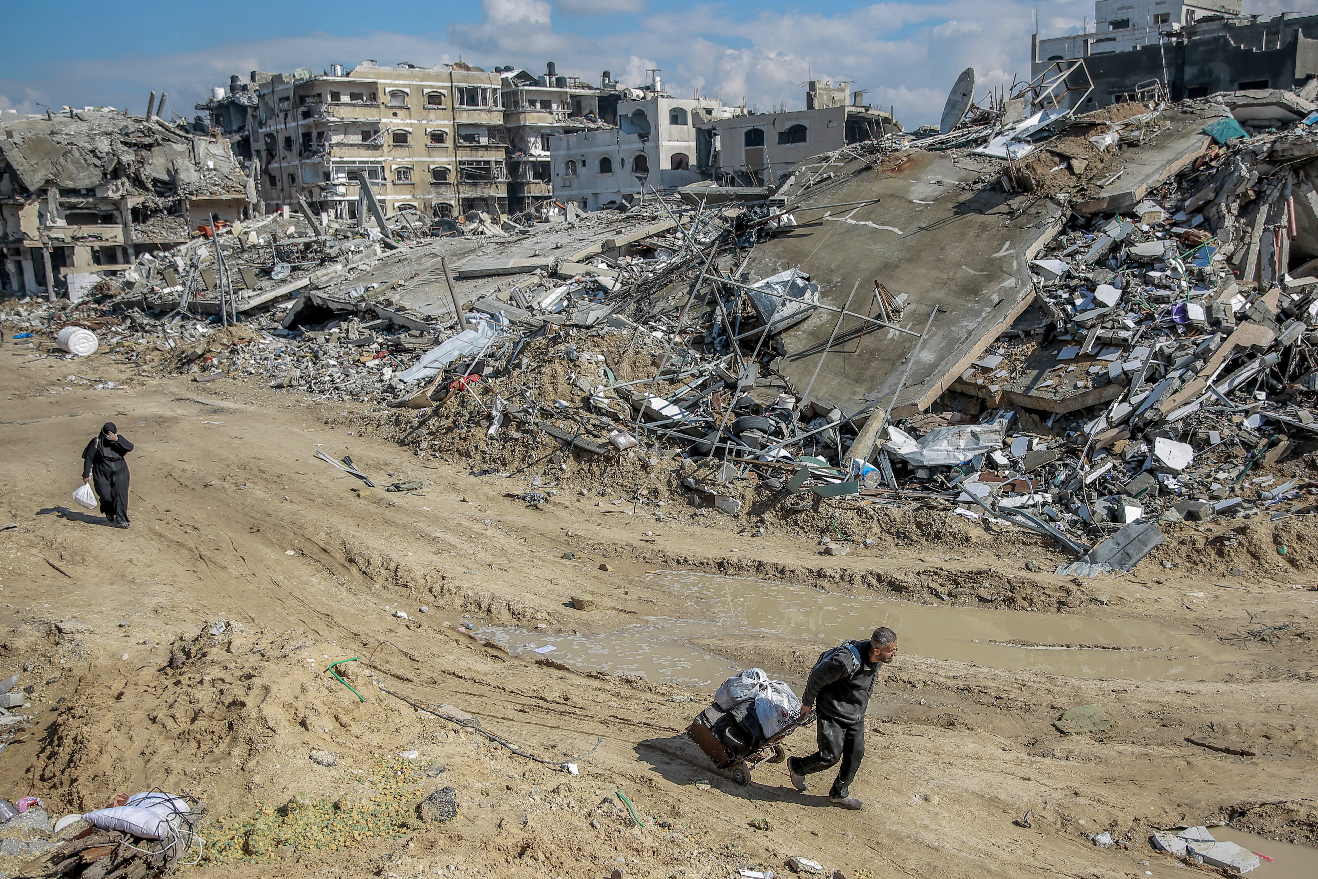 People look for salvageable items at Al-Maqoussi towers area on February 3, 2024, amid the rubble of buildings destroyed during Israeli bombardment on Gaza City, as battles continue between Israel and the Palestinian militant group Hamas. (Photo by AFP)