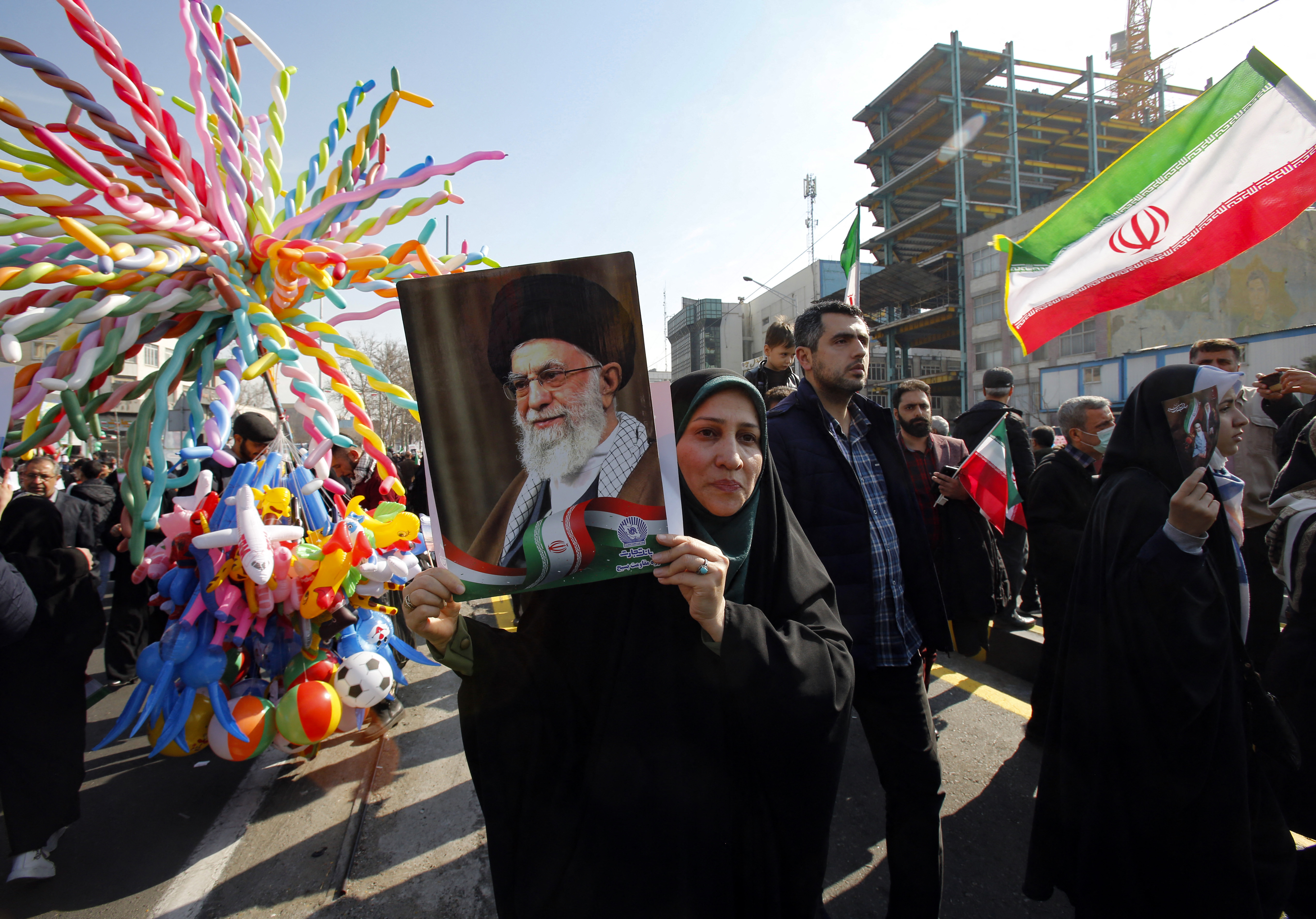 A woman raises a portrait of Iran's Supreme Leader Ayatollah Ali Khamenei, as people gather to mark the 45th anniversary of the Islamic revolution in Tehran on February 11, 2024. - Iran marked 45 years since the Islamic revolution with a ceremony on February 11