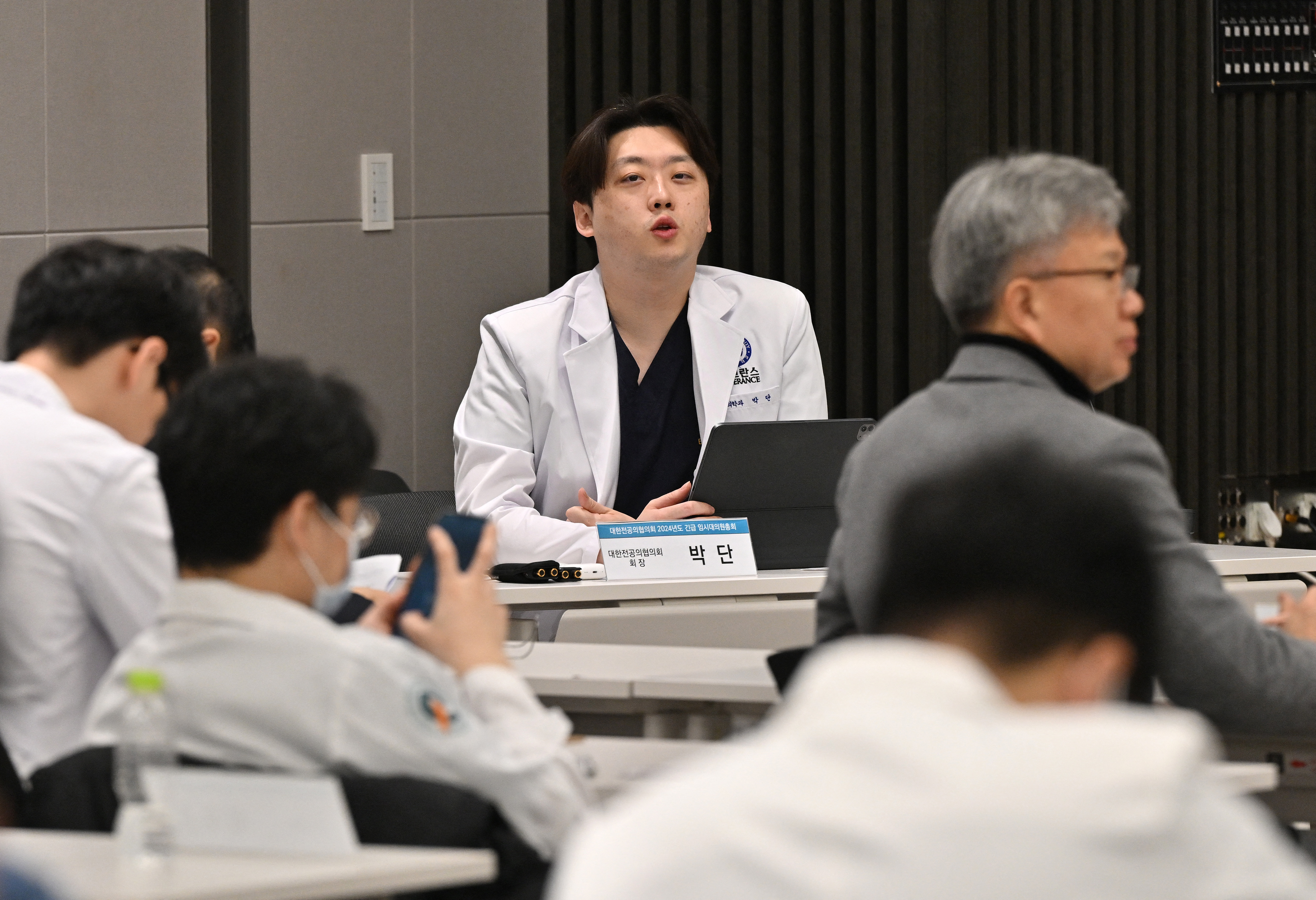 Park Dan (C), head of the Korea Intern Resident Association, speaks at an emergency meeting with trainee doctors at the Korean Medical Association building on February 20, 2024.