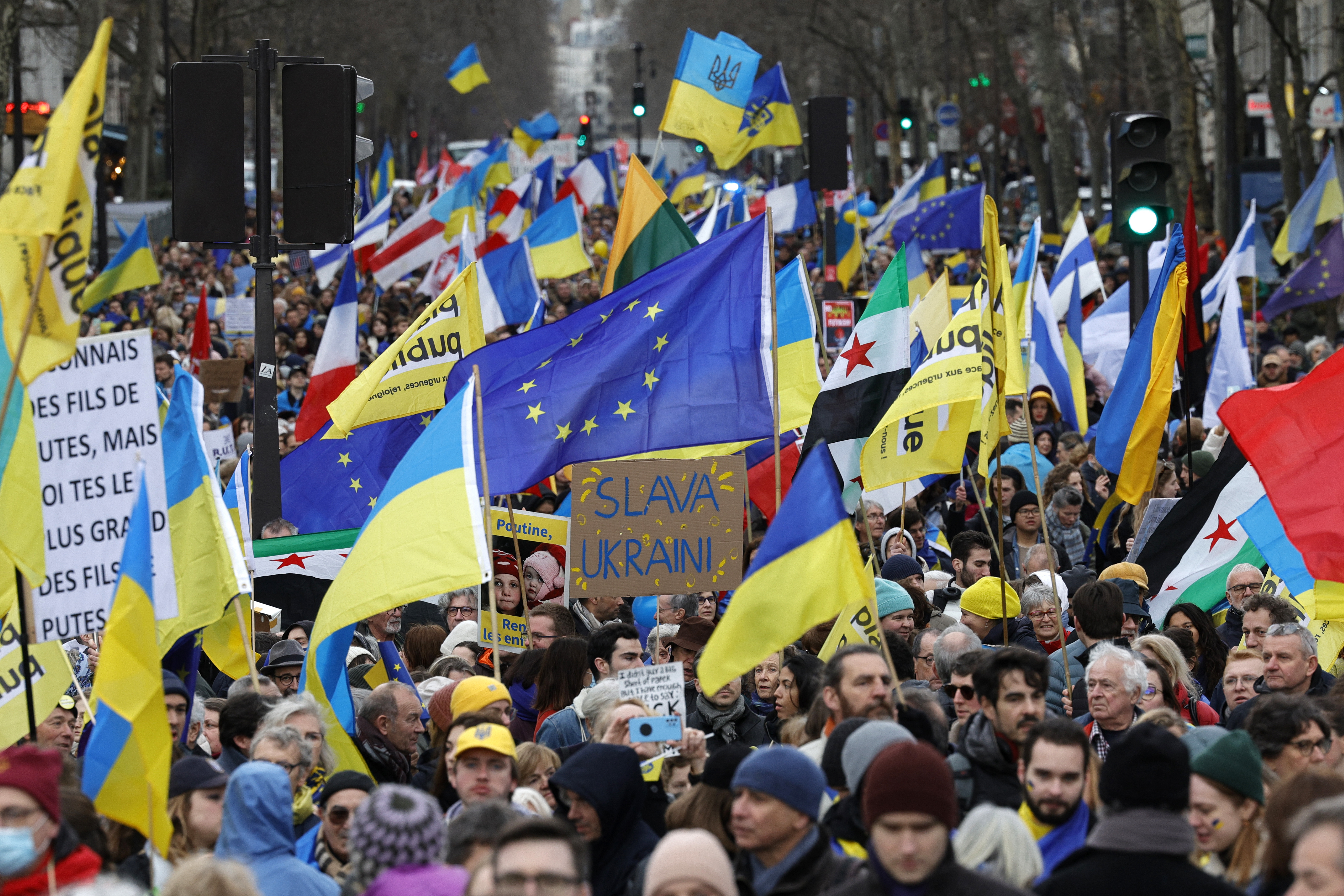 Participants wave European and Ukrainian flags during a rally for Ukraine on the second anniversary of Russia's invasion, in Paris on February