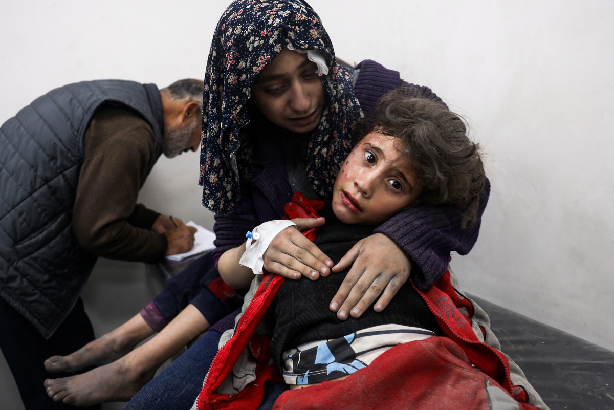Injured Palestinian girls sit at the Kuwait Hospital in Rafah,