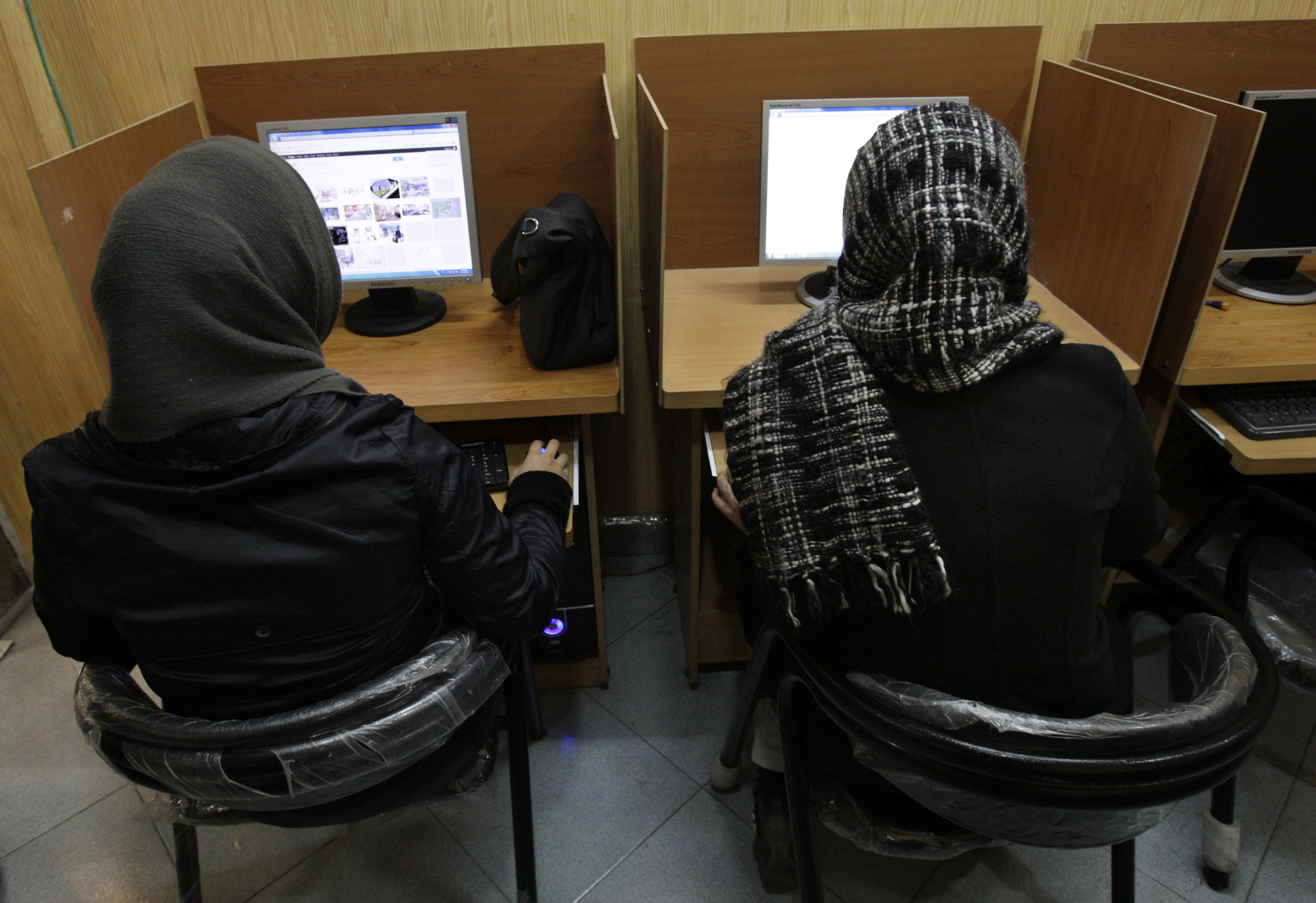 Iranian women use computers at an Internet cafe in central Tehran, Iran, Monday, Feb. 13, 2012. Many Iranian web users say their access to foreign email services such as Gmail, Yahoo mail and Hotmail appears to have been restored after a four day outage. (AP Photo/Vahid Salemi)
