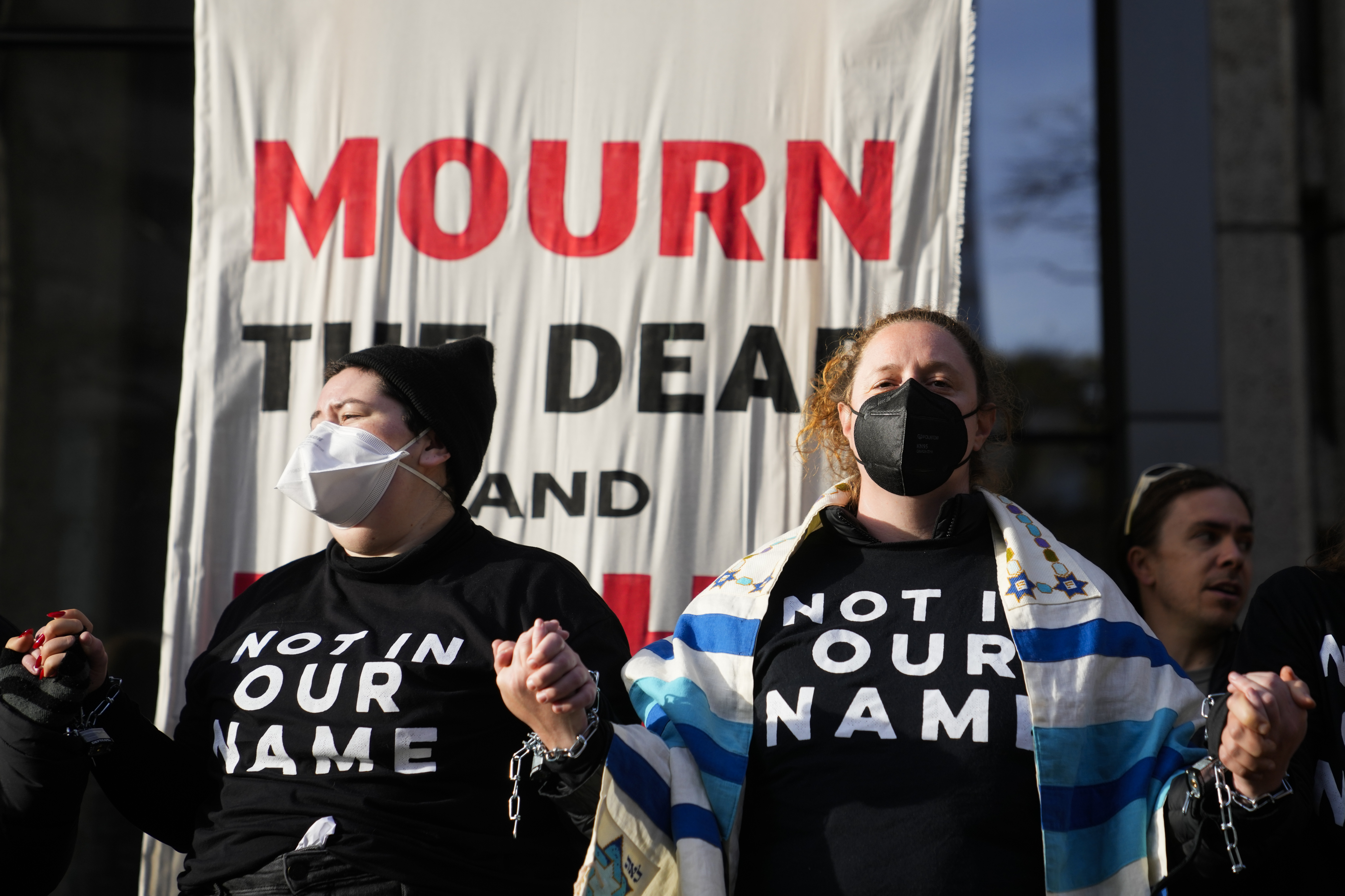 Protesters hold hands locked together during a Jewish Voice for Peace rally for a ceasefire in Gaza on November 3, 2023, in Seattle, US