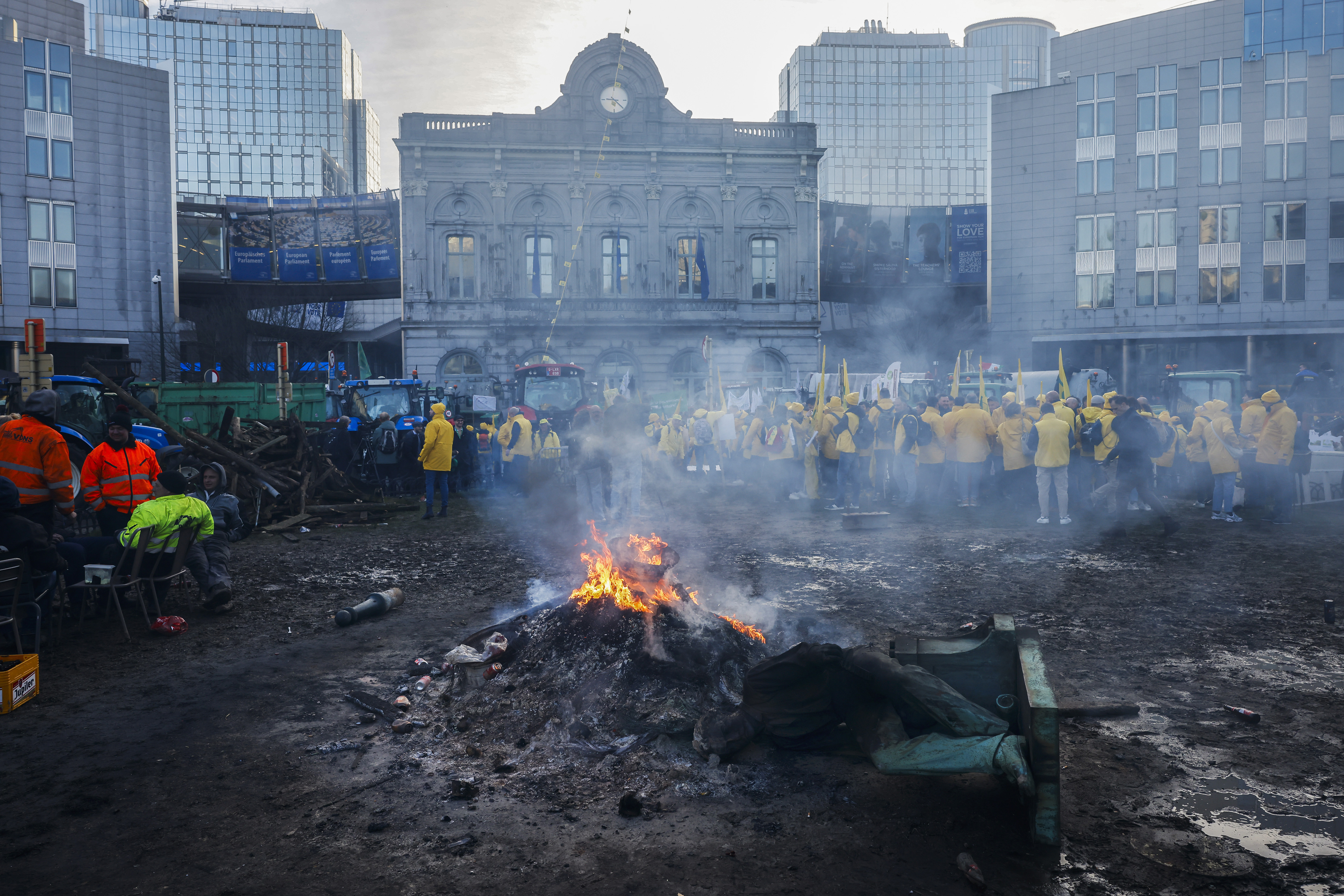 Farmers gather outside the European Parliament for a protest as European leaders meet for an EU summit in Brussels, Thursday, Feb. 1