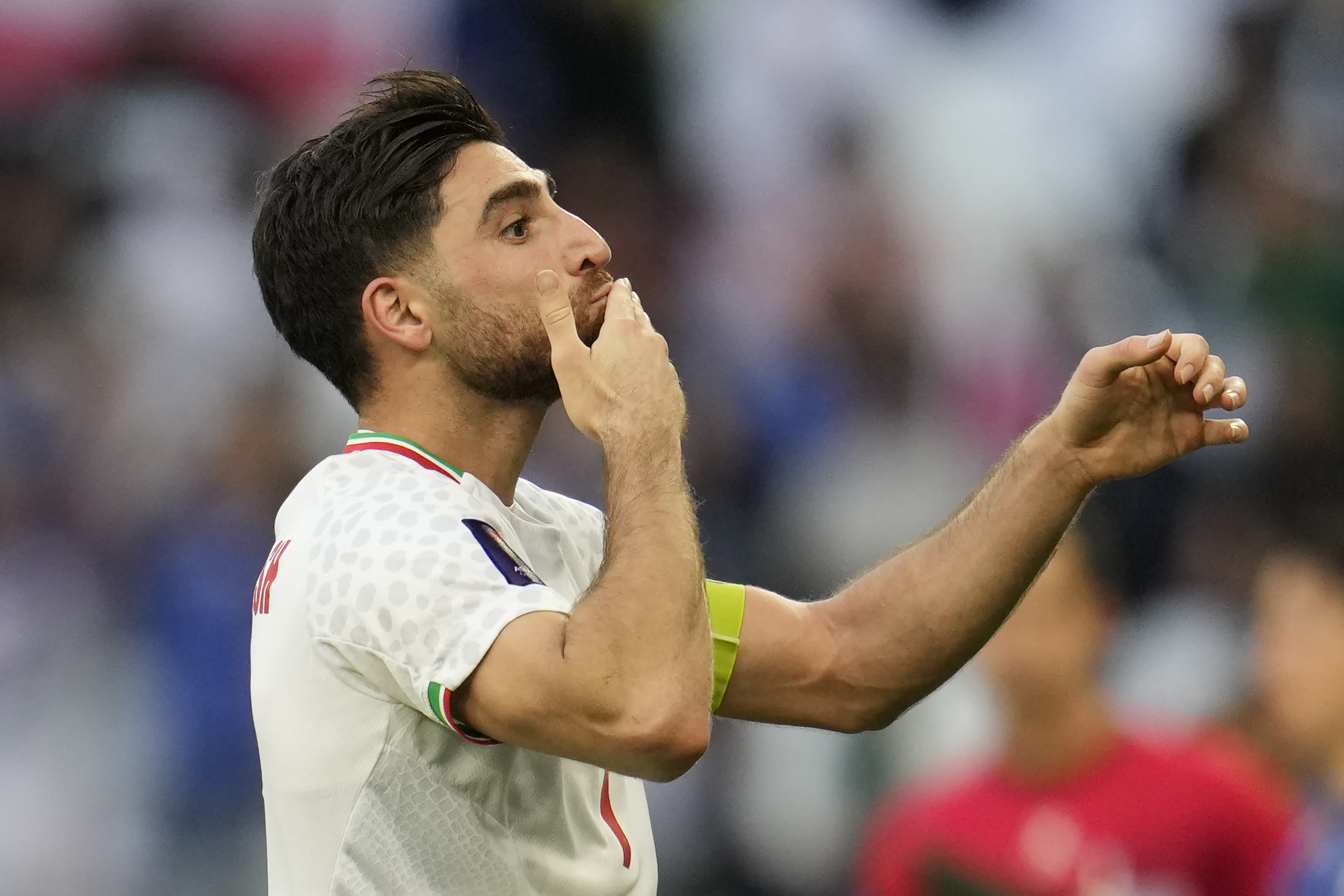 Iran's Alireza Jahan Bakhsh celebrates after converting a penalty