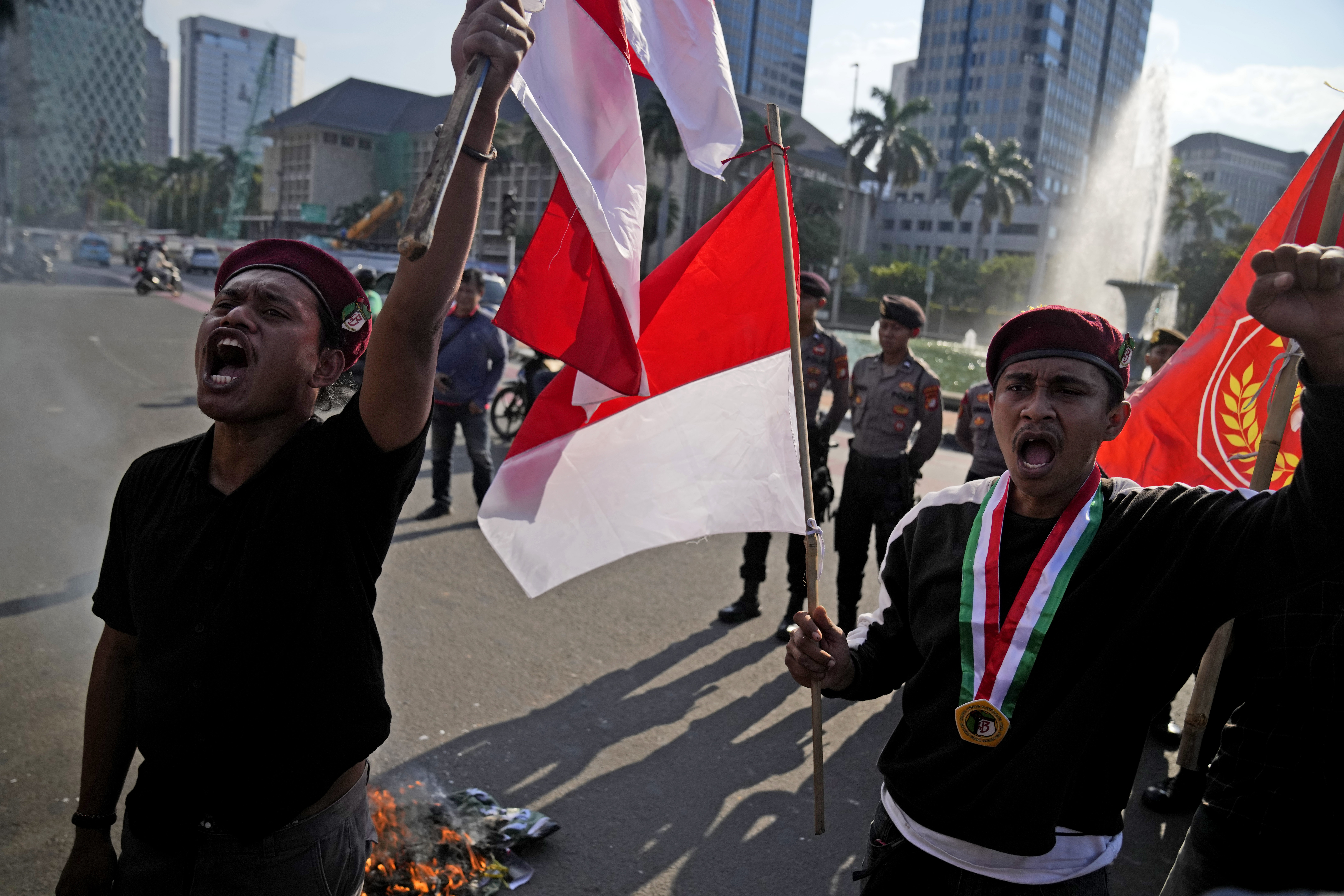 Students on the streets of Jakarta amid concerns about Indonesia's democracy. They are carrying Indonesian flags and raising their fists