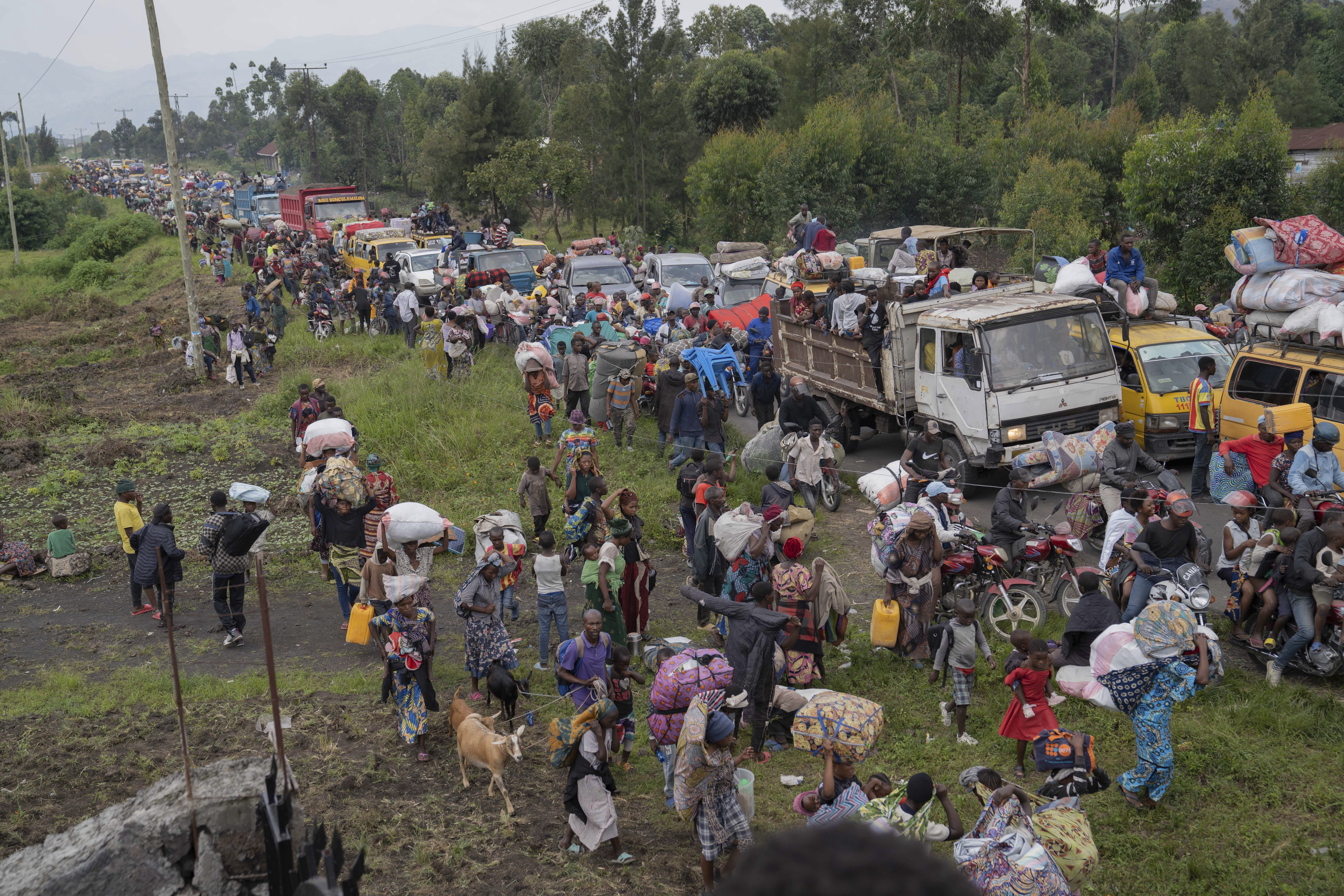 Thousands who are fleeing the ongoing conflict between government forces and M-23 rebels reach the entrance the Democratic Republic of Congo eastern city of Goma Wednesday, Feb. 7