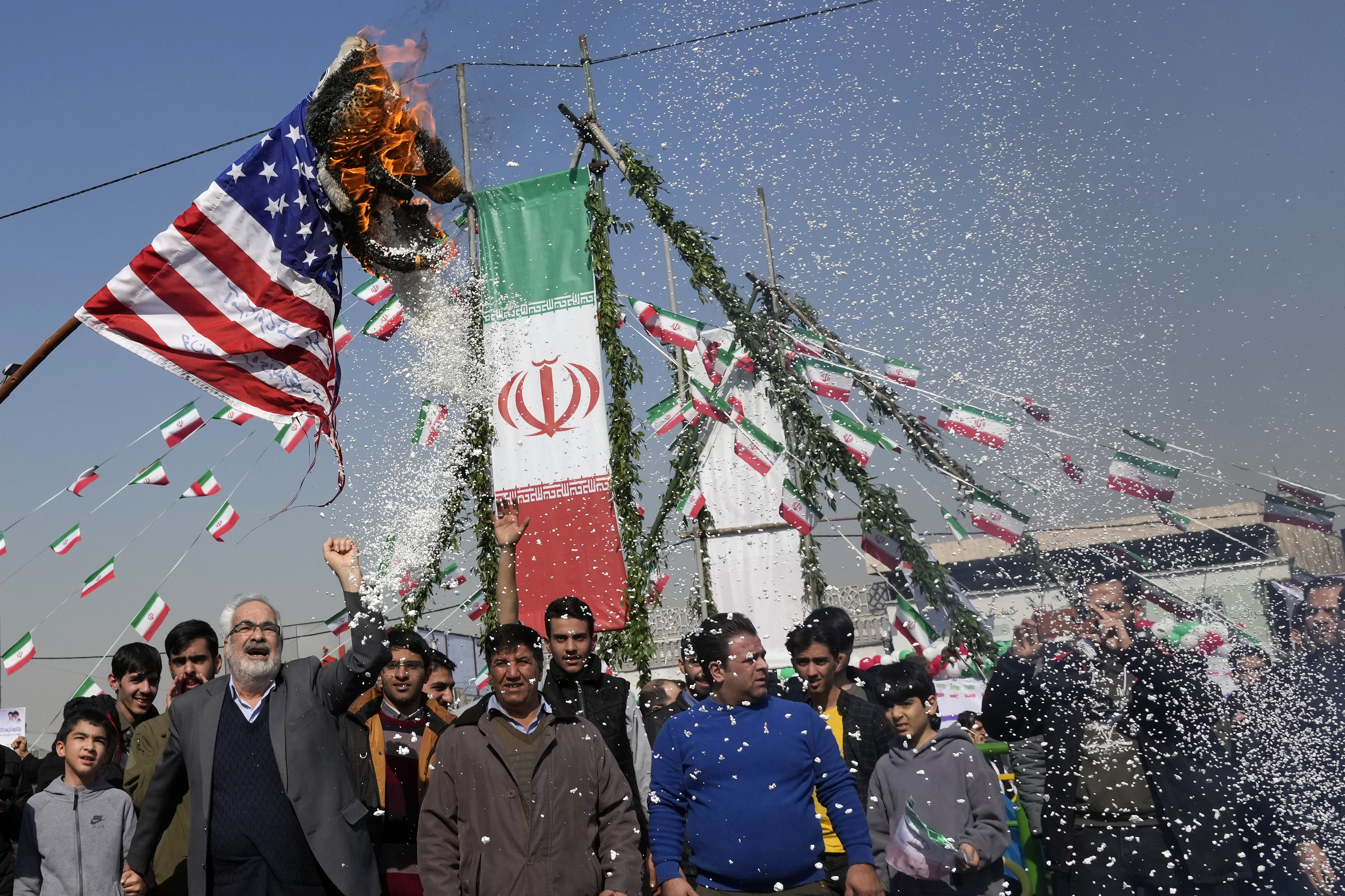 Demonstrators burn a U.S. flag during their annual rally commemorating Iran's 1979 Islamic Revolution in Tehran, Iran, Sunday