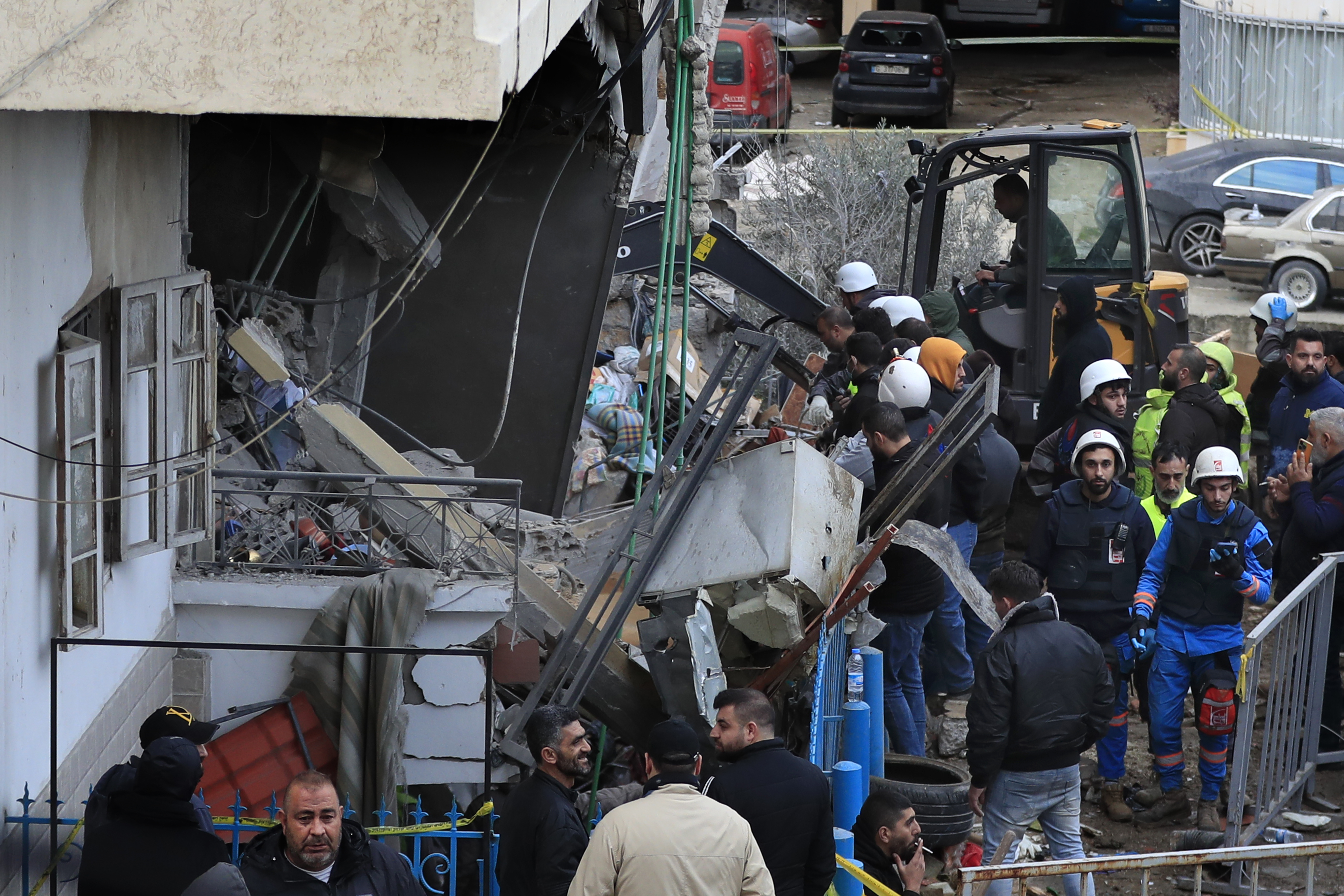 Rescuers work at a damaged buidling following an Israeli military strike in Nabatiyeh