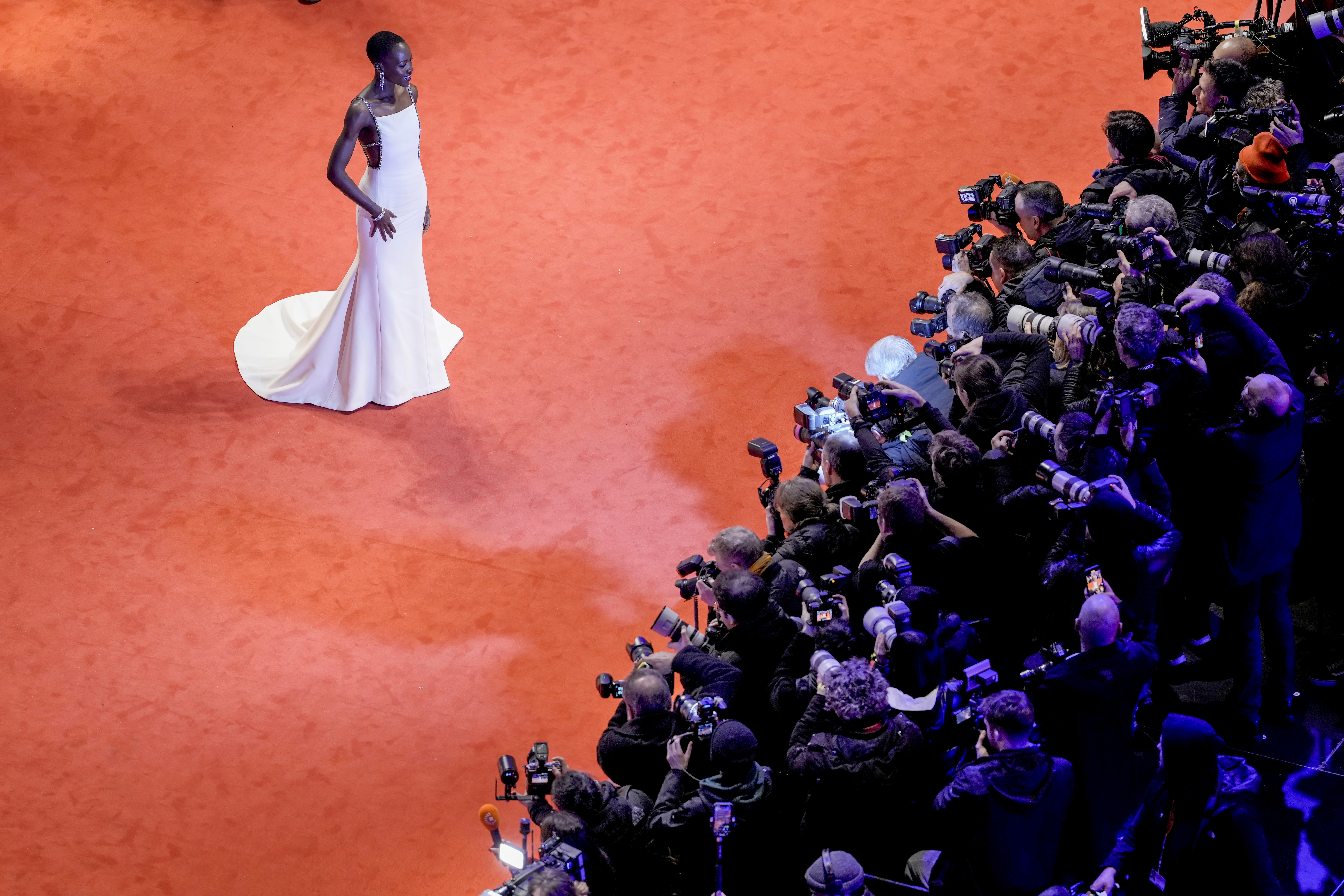 The president of the International Jury Lupita Nyong'o stands on the red carpet leading to the Berlinale Palast for the opening of the International Film Festival, Berlinale,in Berlin, Thursday, Feb. 15