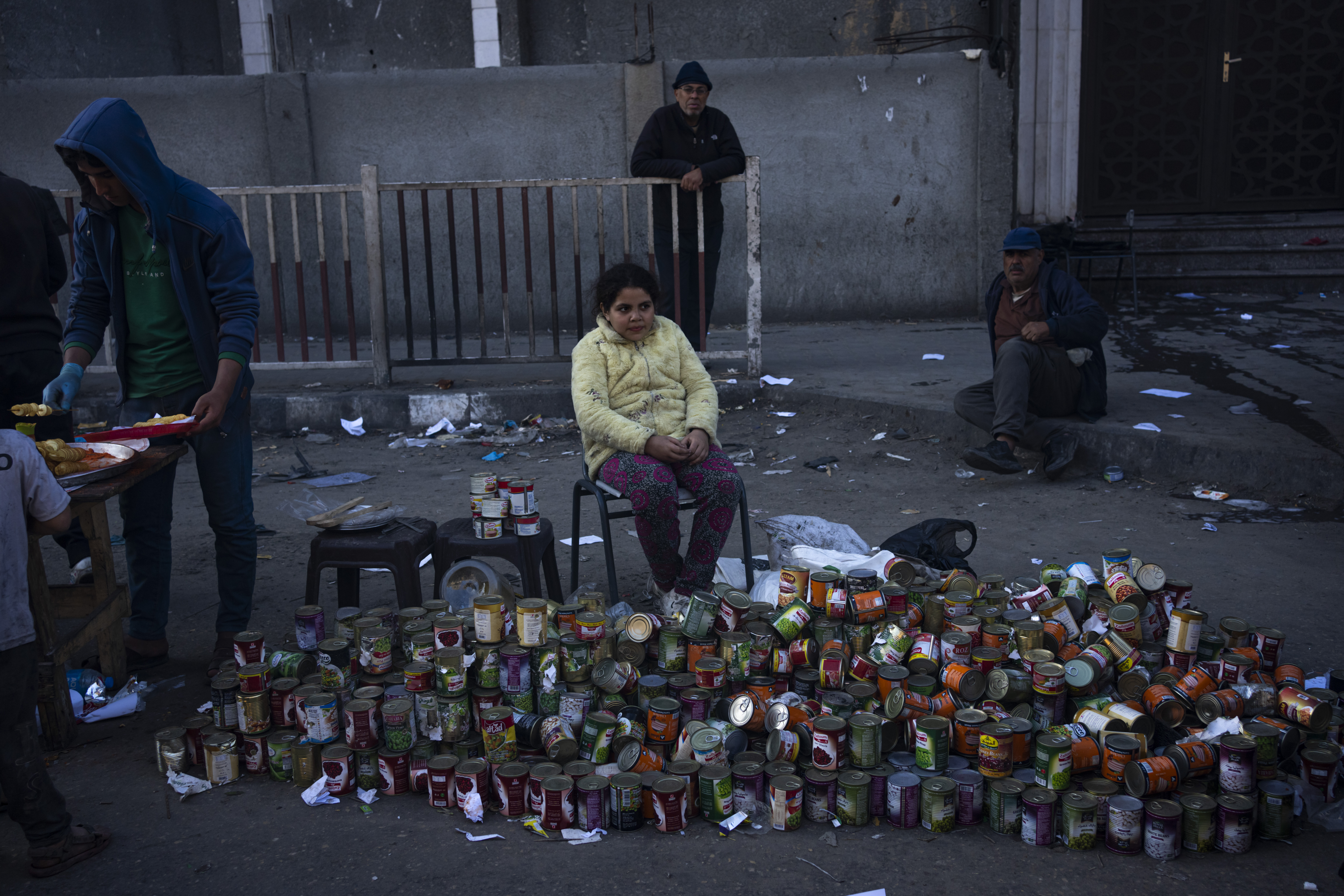 Palestinians sell canning in a street market in Rafah, Gaza Strip, Tuesday, Feb. 20