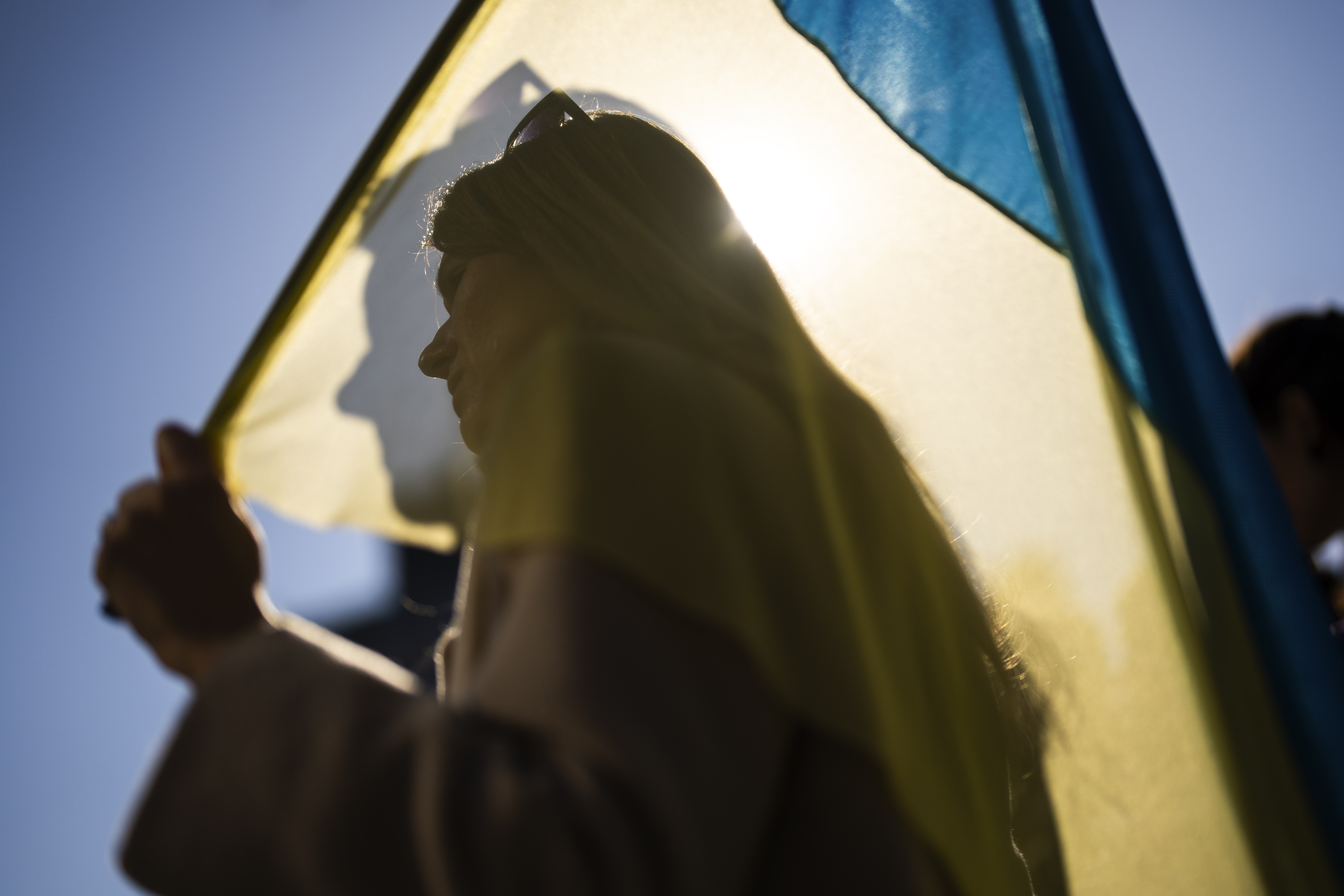 A woman holds a Ukrainian flag during a protest marking the second year of the invasion of Ukraine by Russia, in Istanbul, Turkey, Saturday