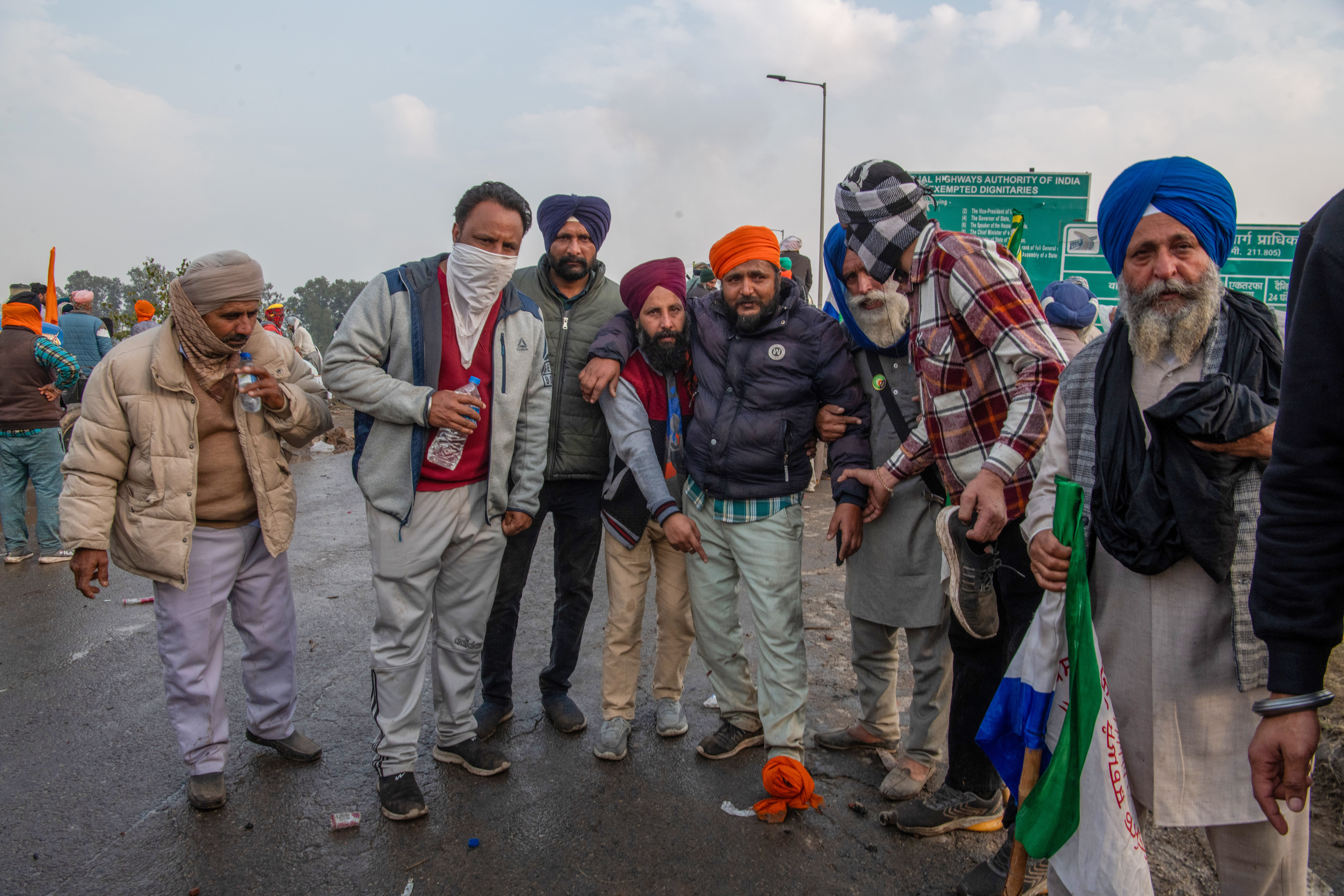 Protesting farmers assist an injured farmer hurt during clashes with police at the Sindhu border. As soon as the farmers attempt to remove the barricade and move towards Delhi, police fire tear gas shells and rubber bullets to disperse them, resulting in injuries to several.