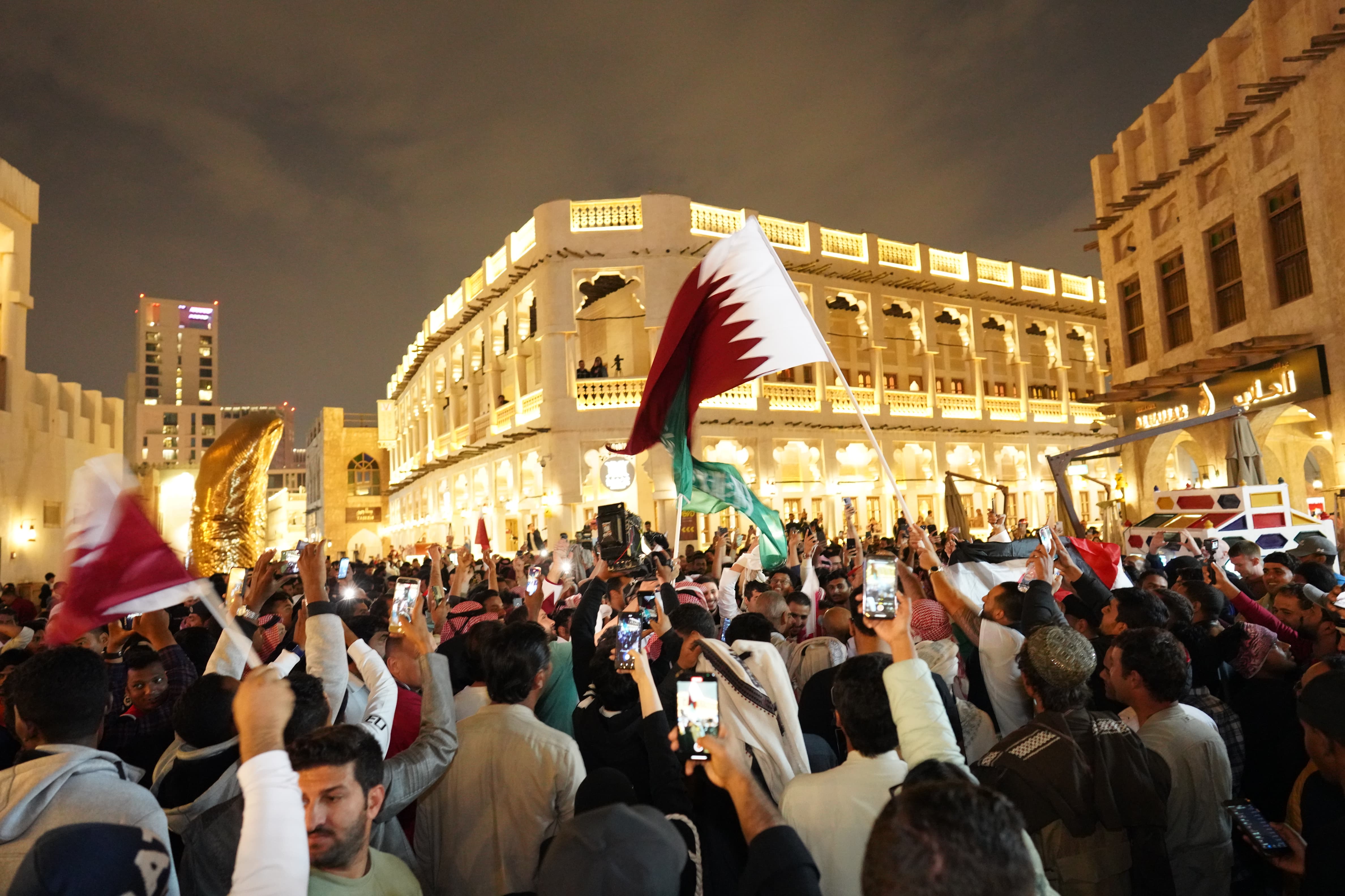 Qatar fans celebrate their team winning the AFC Asian Cup in Doha's Souq Waqif [Sorin Furcoi/Al Jazeera]